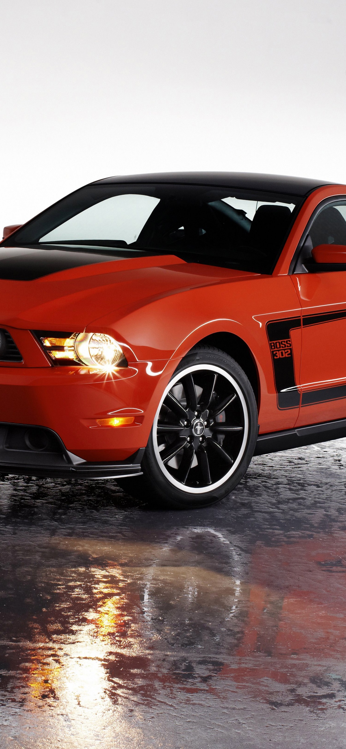 Orange Bmw m 3 Coupe on Snow Covered Ground. Wallpaper in 1125x2436 Resolution