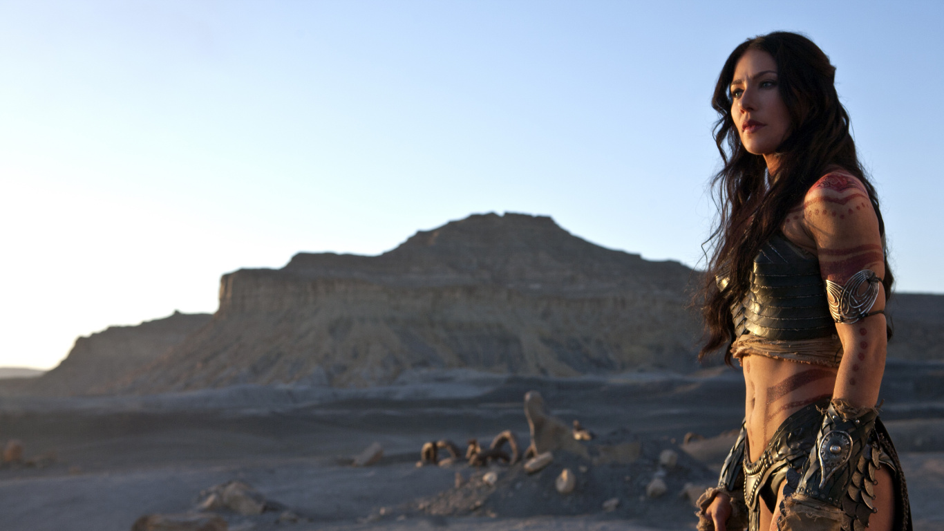 Woman in Brown Sleeveless Dress Standing on Brown Sand During Daytime. Wallpaper in 1366x768 Resolution