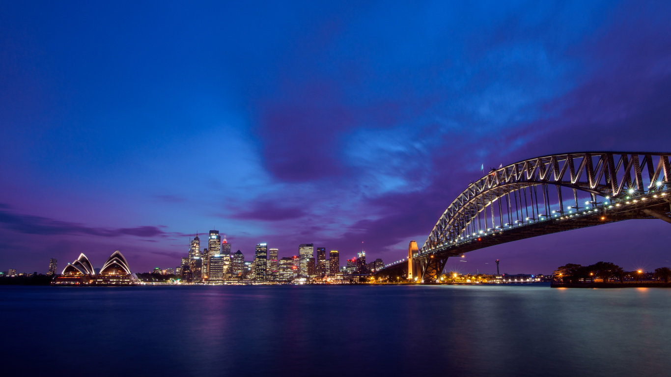 Skyline Der Stadt Unter Blauem Himmel Während Der Nacht. Wallpaper in 1366x768 Resolution