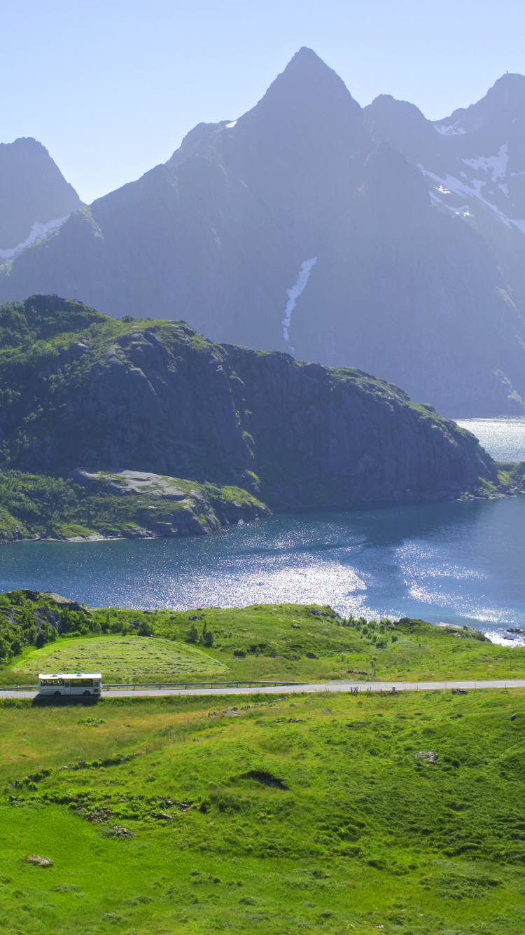 Green Grass Field Near Body of Water During Daytime. Wallpaper in 750x1334 Resolution