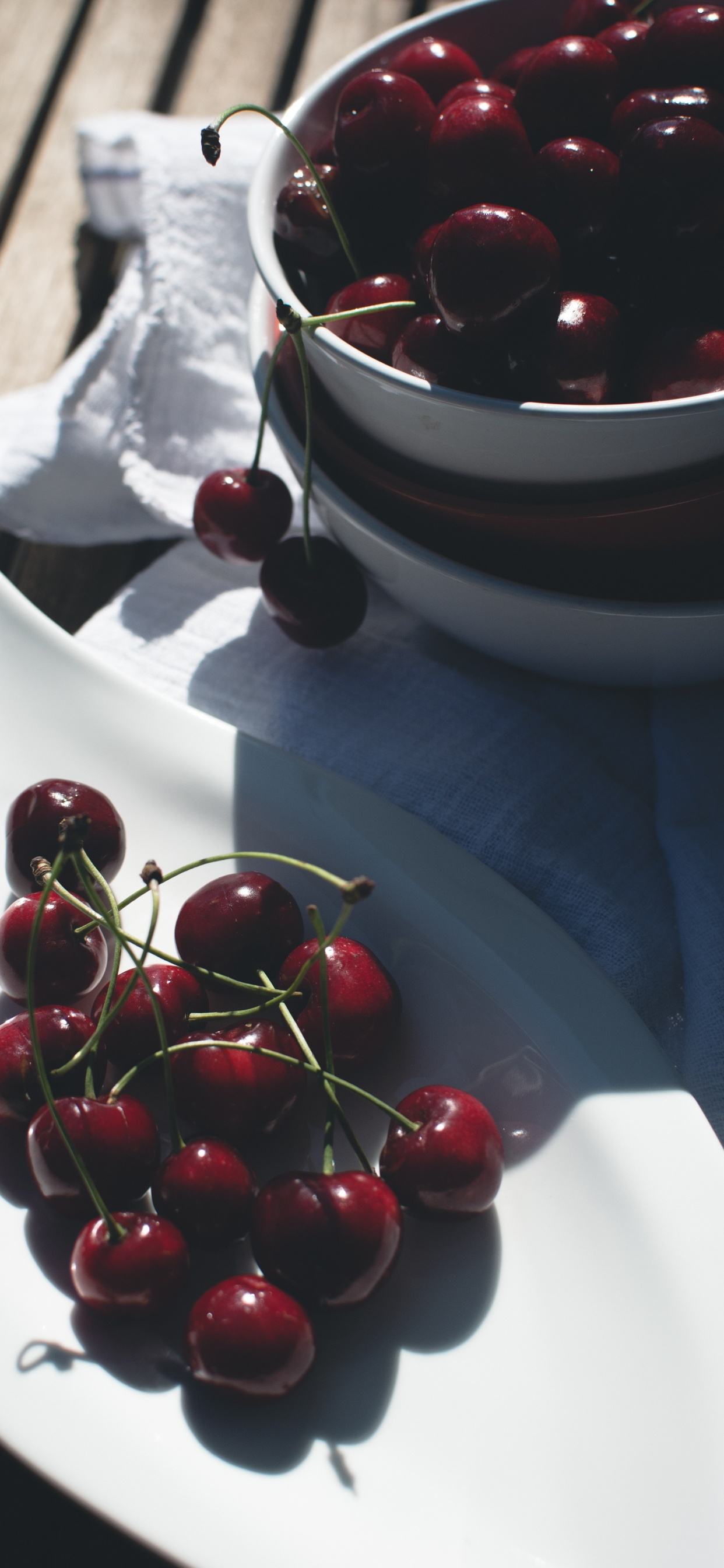 Red Cherries on White Ceramic Bowl. Wallpaper in 1242x2688 Resolution