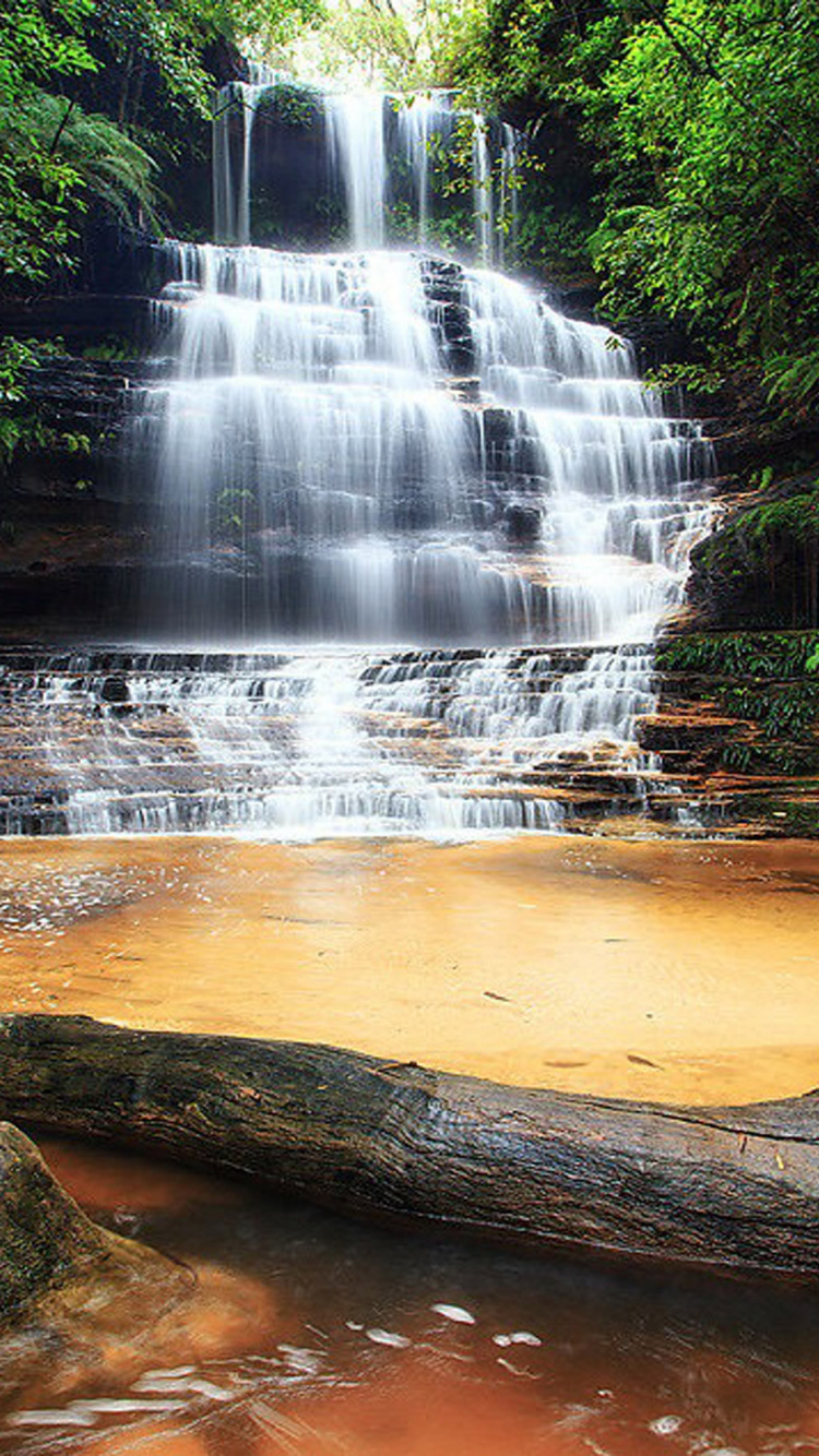 Water Falls on Brown Rocky Shore During Daytime. Wallpaper in 750x1334 Resolution