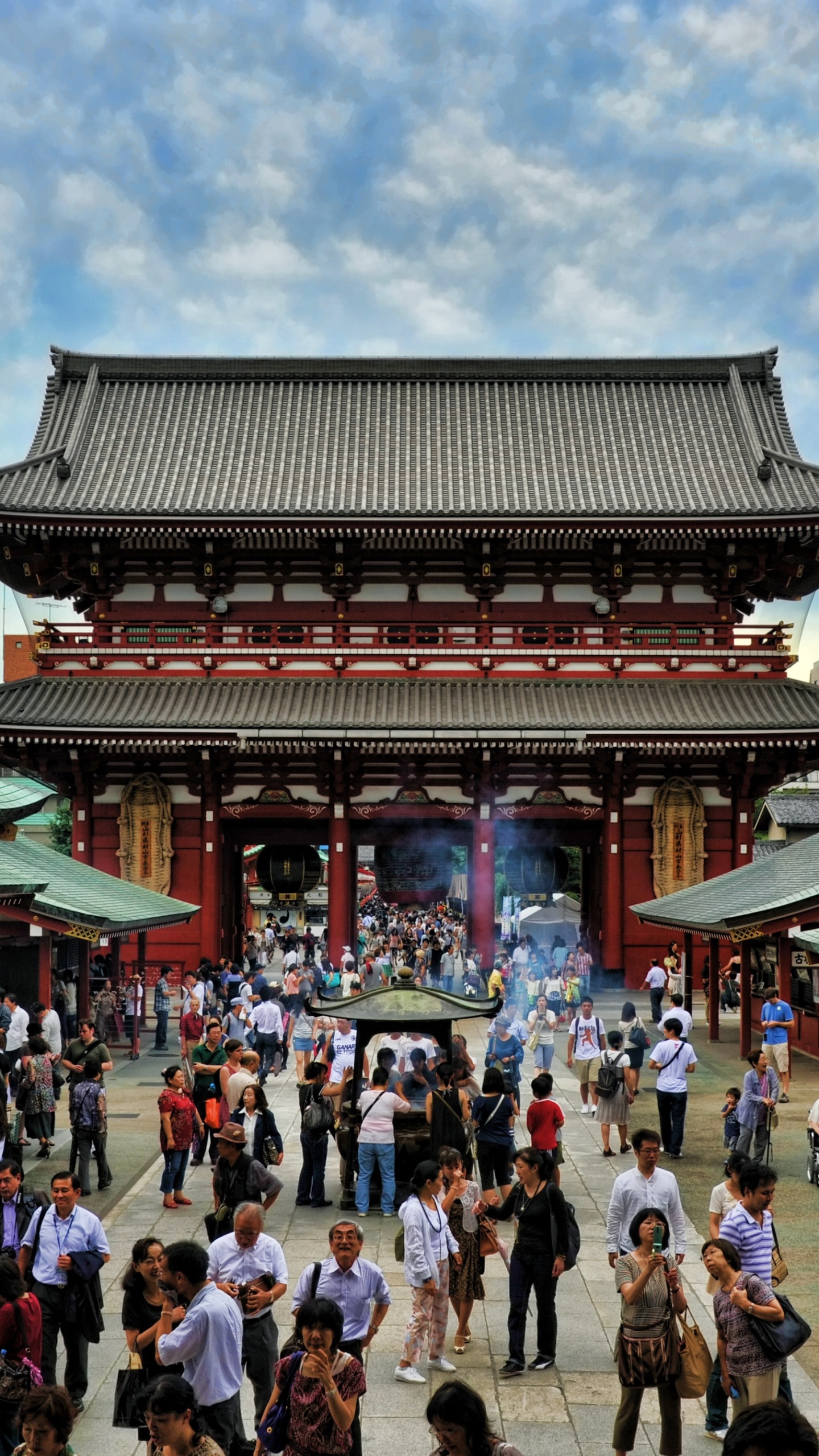 People Walking on Street Near Green and Brown Temple During Daytime. Wallpaper in 1440x2560 Resolution