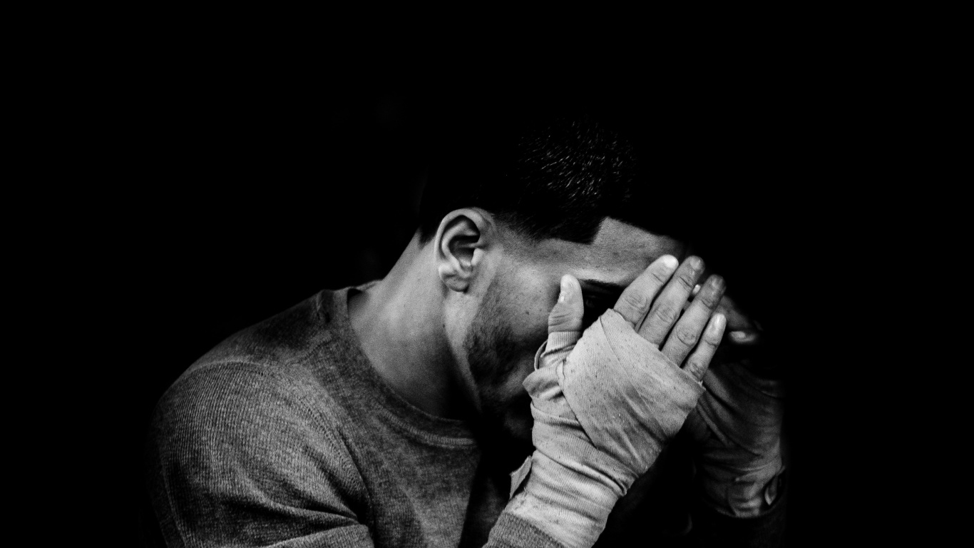 Man in Long Sleeve Shirt Covering His Face. Wallpaper in 1366x768 Resolution