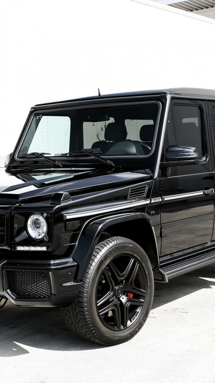 Black Suv on Gray Concrete Road During Daytime. Wallpaper in 750x1334 Resolution