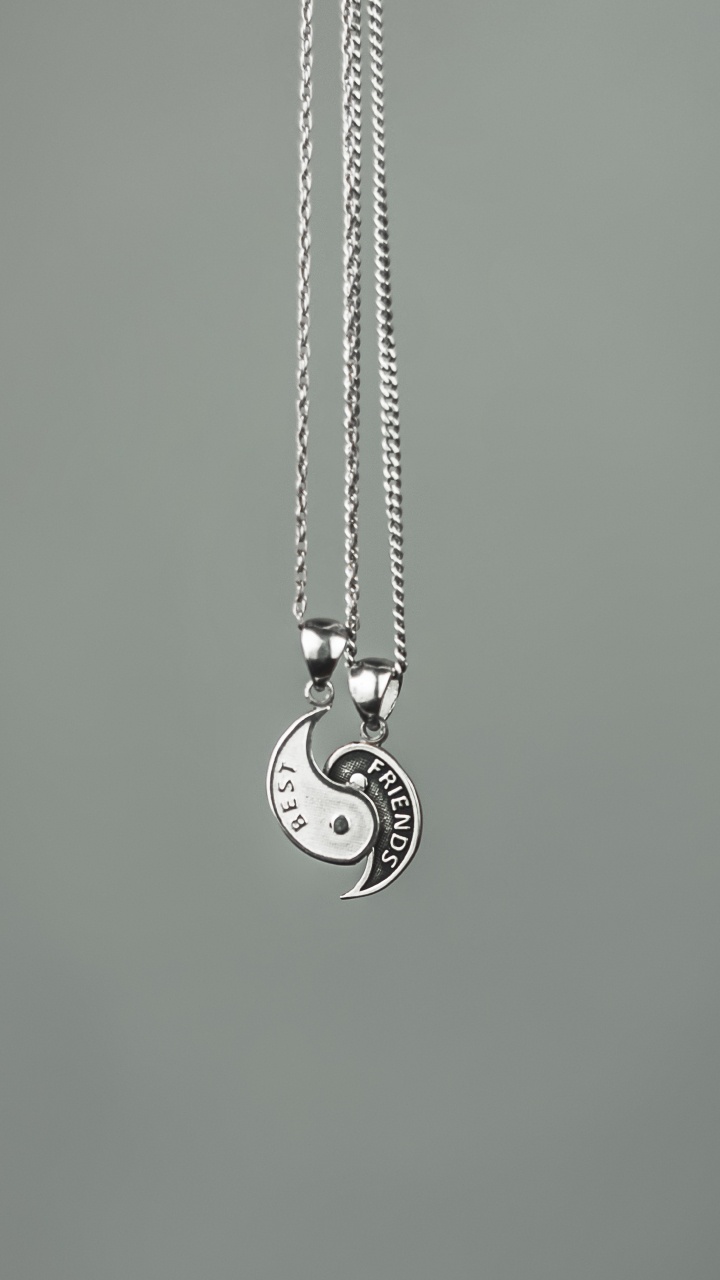 Silver Heart Pendant Necklace on Green Surface. Wallpaper in 720x1280 Resolution