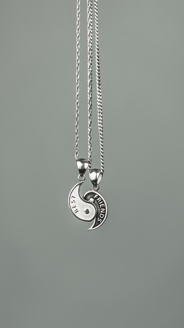 Silver Heart Pendant Necklace on Green Surface. Wallpaper in 750x1334 Resolution