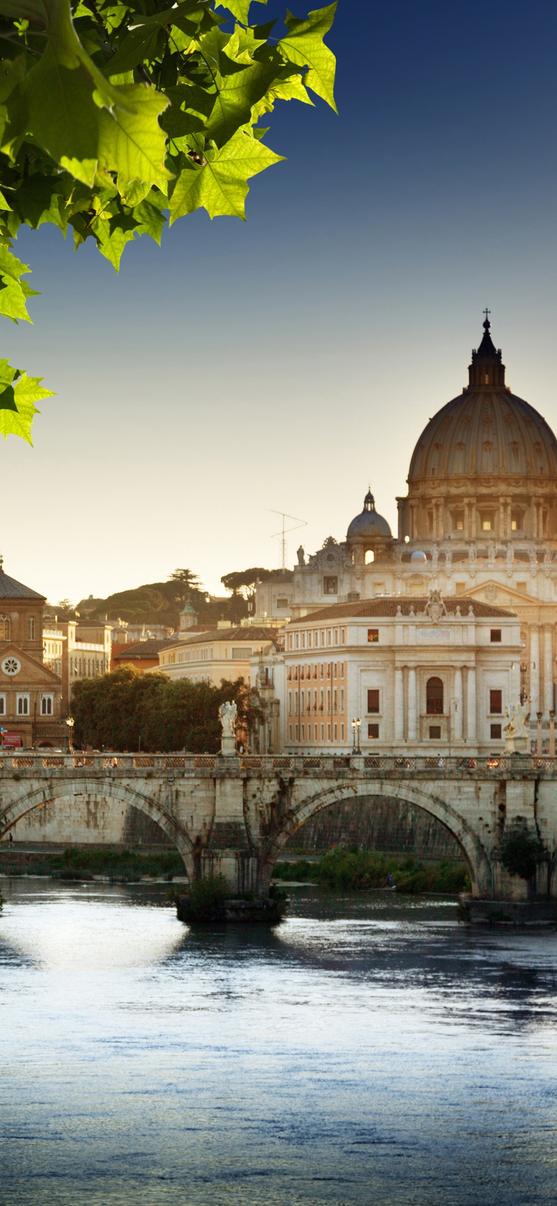 Brown Concrete Building Near Green Trees During Daytime. Wallpaper in 1125x2436 Resolution