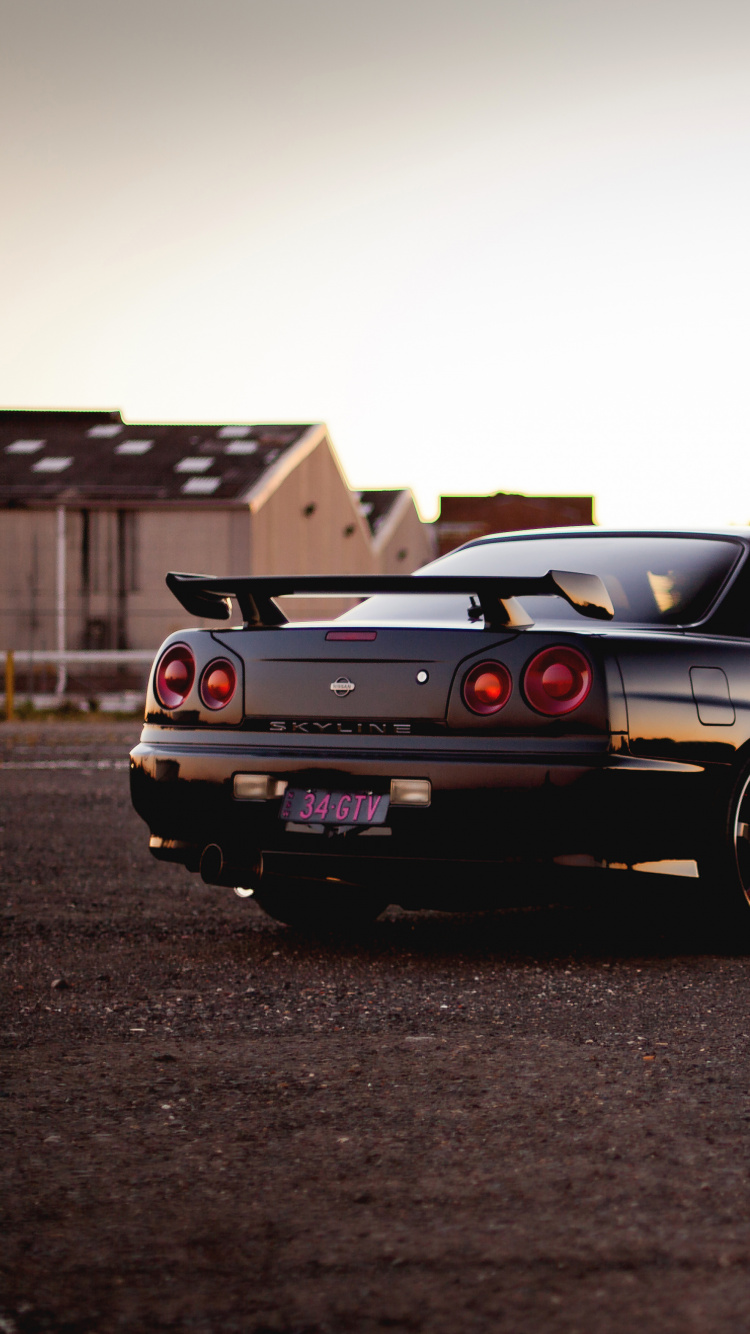 Black Coupe on Road During Daytime. Wallpaper in 750x1334 Resolution