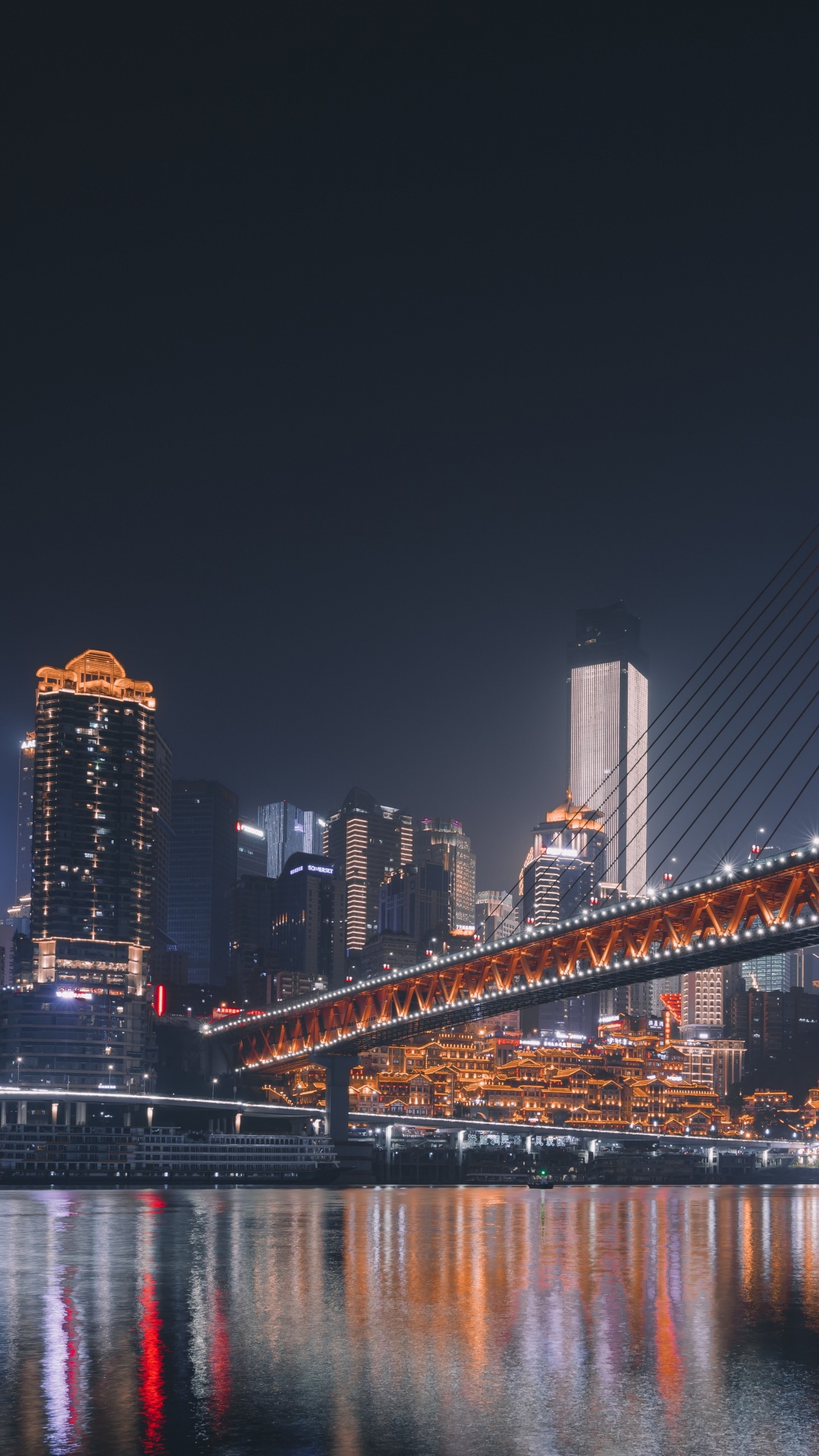 Blue Bridge Over Water During Night Time. Wallpaper in 1080x1920 Resolution