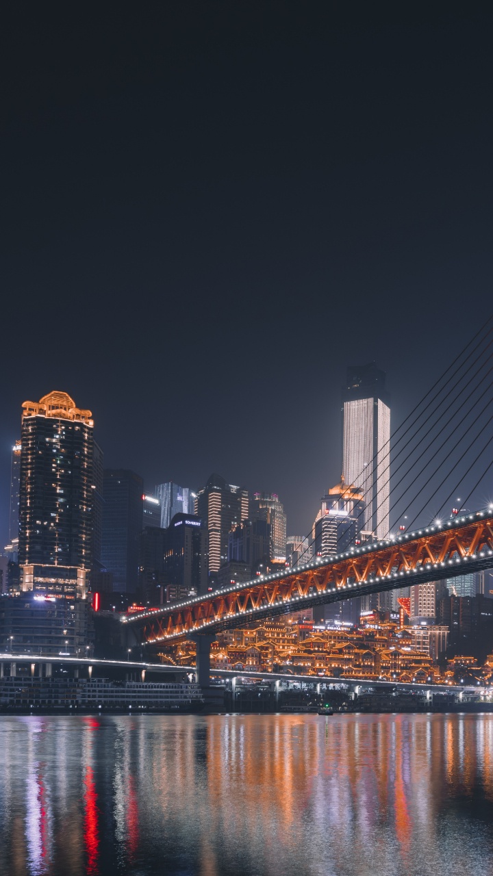 Blue Bridge Over Water During Night Time. Wallpaper in 720x1280 Resolution