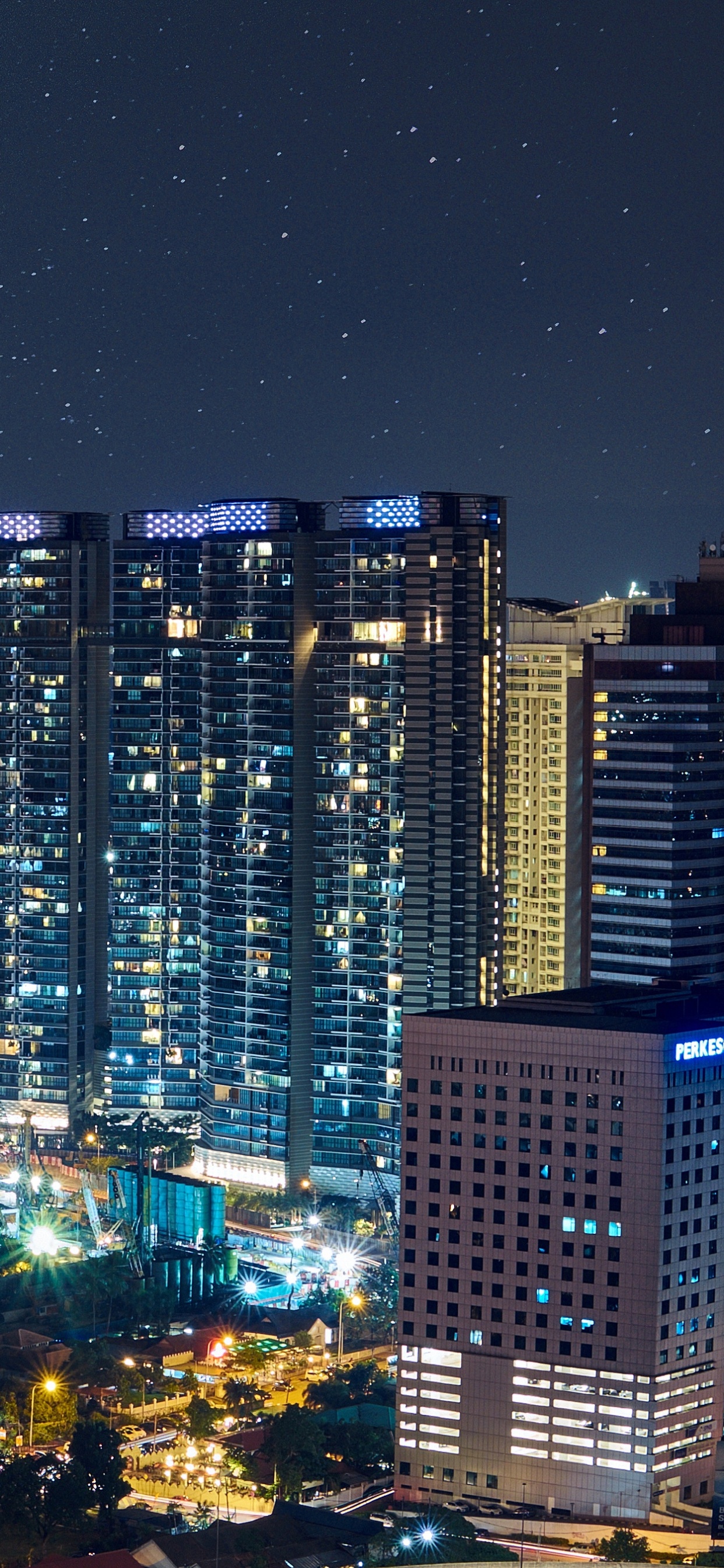 City With High Rise Buildings During Night Time. Wallpaper in 1242x2688 Resolution