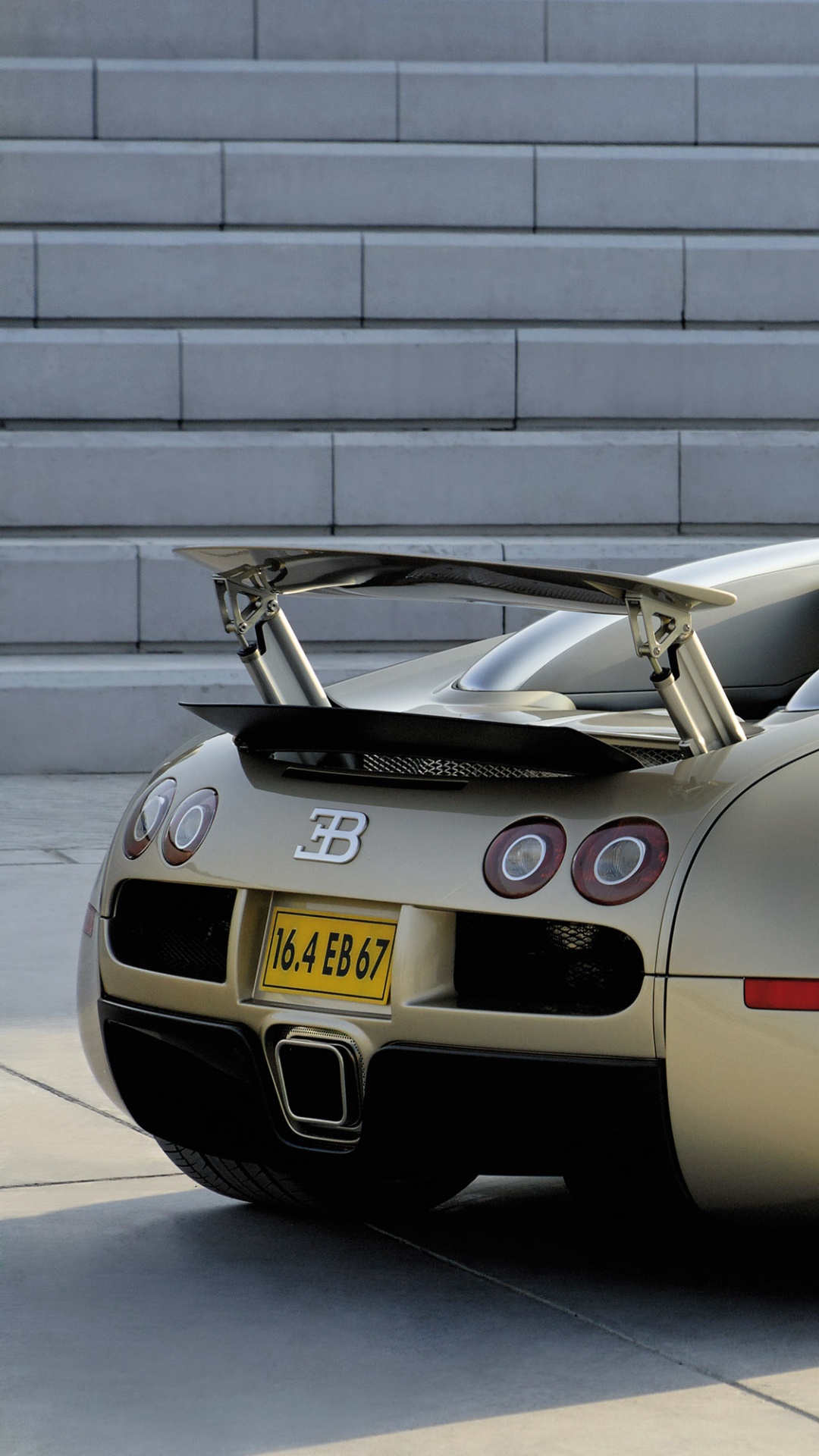 Black Porsche 911 Parked in Front of Gray Brick Wall. Wallpaper in 1080x1920 Resolution