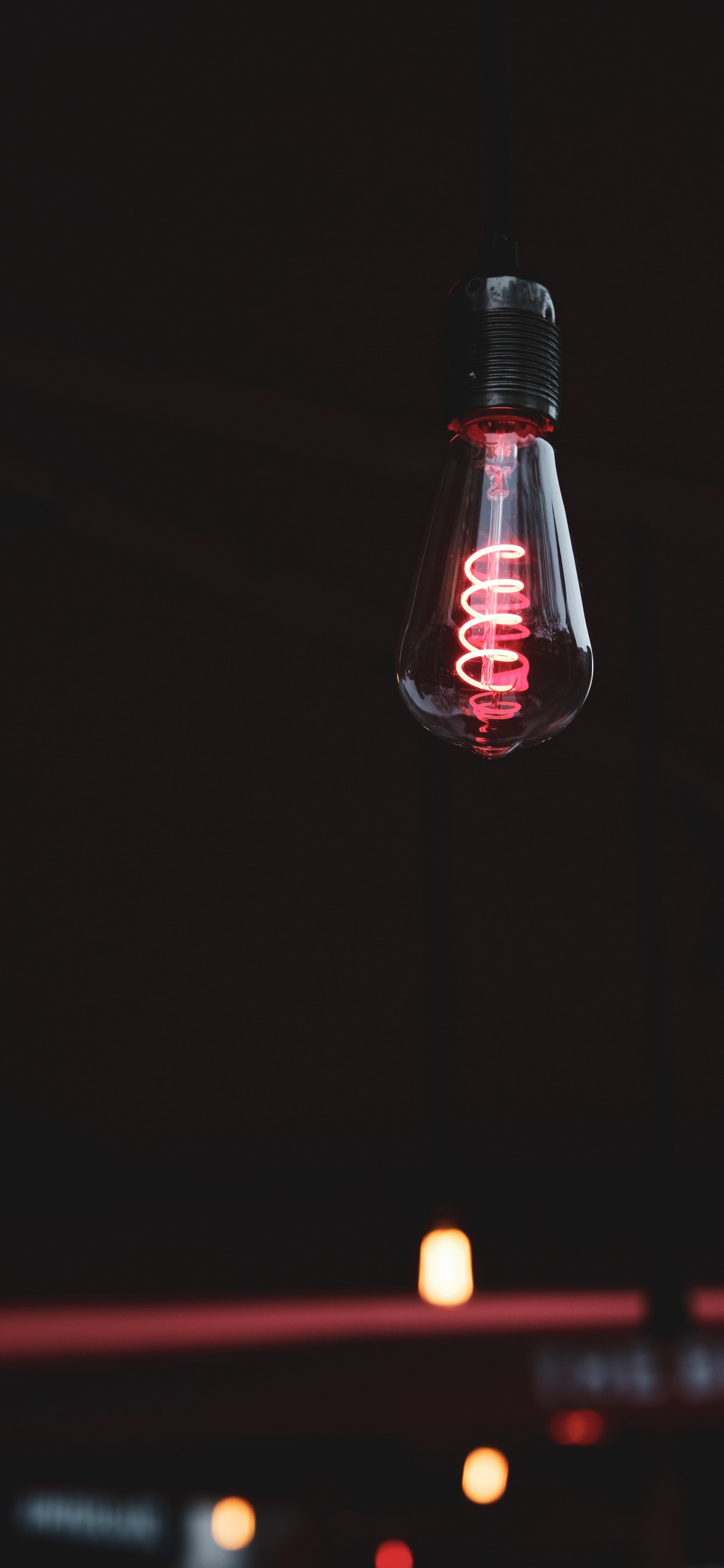 Red and White Light Bulb. Wallpaper in 1125x2436 Resolution