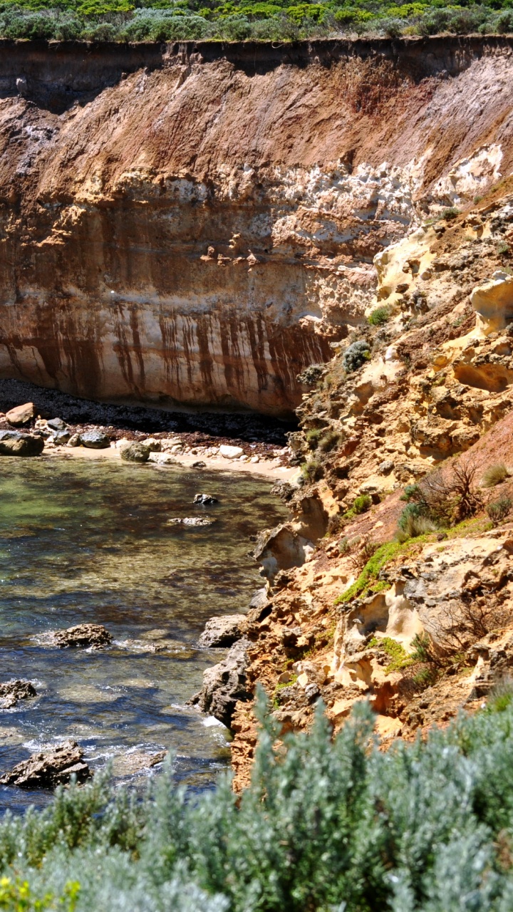 Brown Rock Formation Beside Blue Sea During Daytime. Wallpaper in 720x1280 Resolution