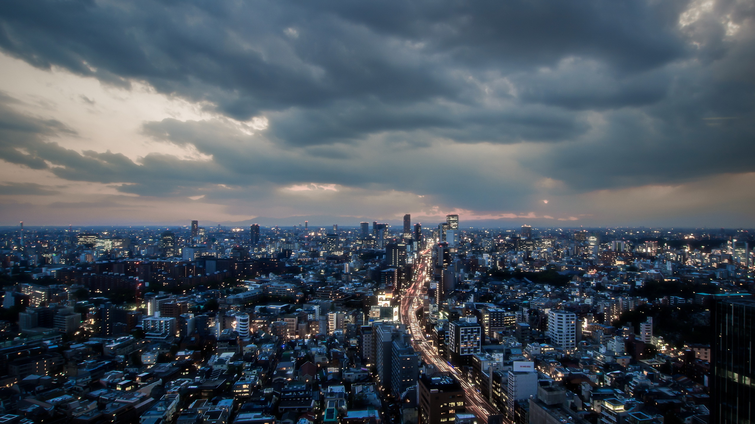 City With High Rise Buildings Under Gray Clouds During Daytime. Wallpaper in 2560x1440 Resolution