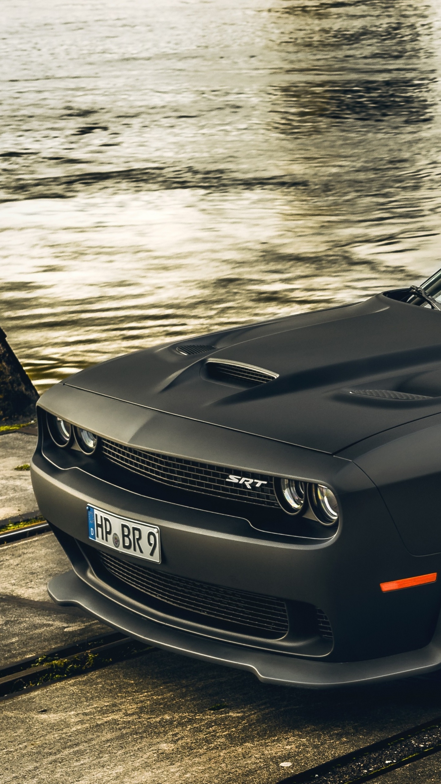 Black Porsche 911 Parked on Gray Concrete Pavement. Wallpaper in 1440x2560 Resolution
