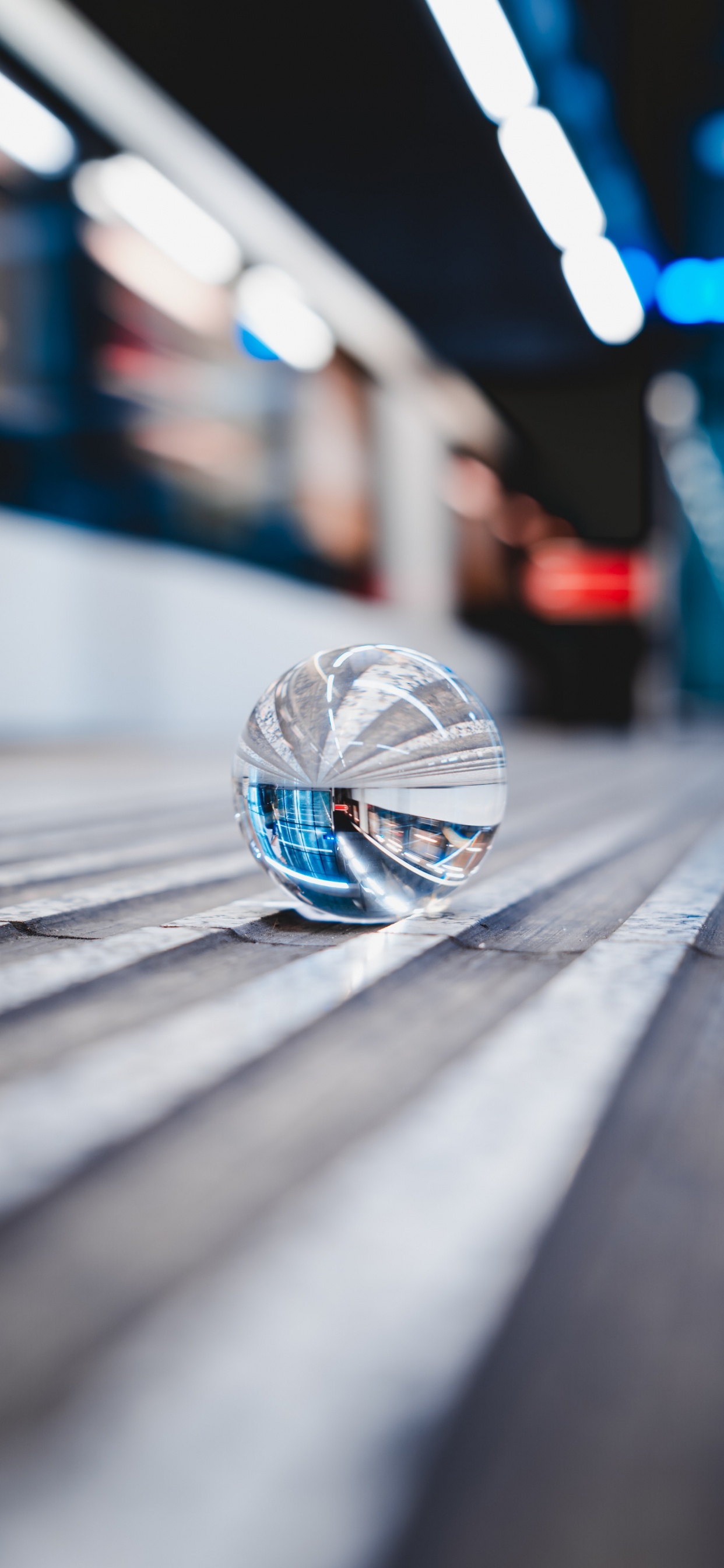 Clear Glass Ball on Gray Wooden Plank. Wallpaper in 1242x2688 Resolution