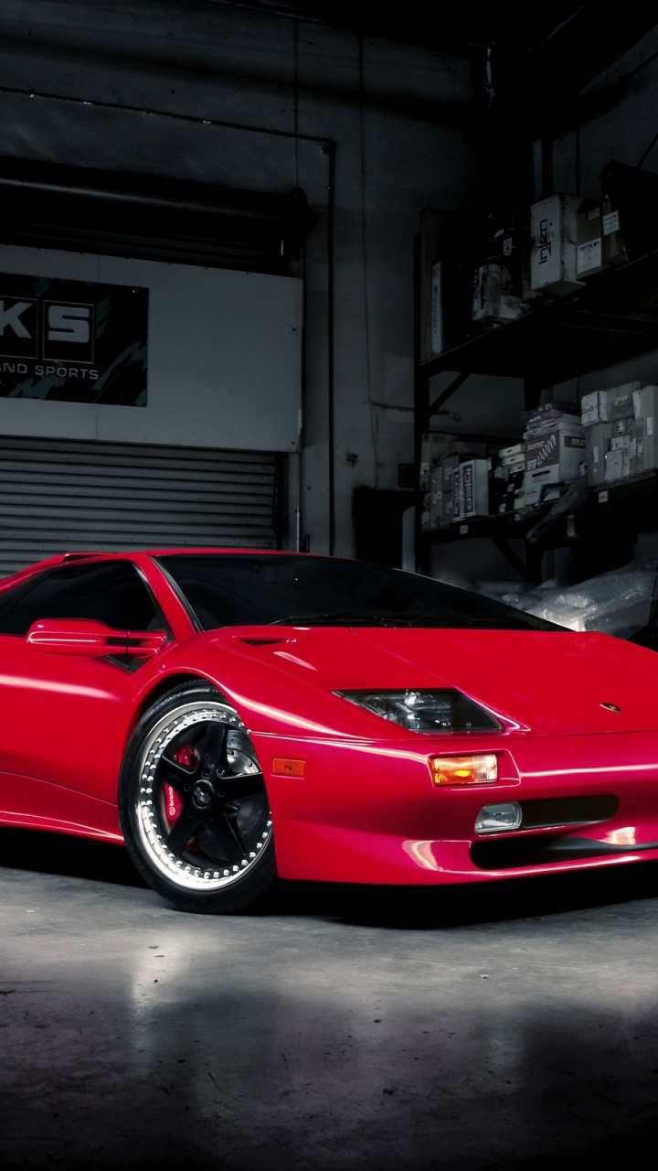 Red Ferrari 458 Italia Parked Near Building. Wallpaper in 720x1280 Resolution