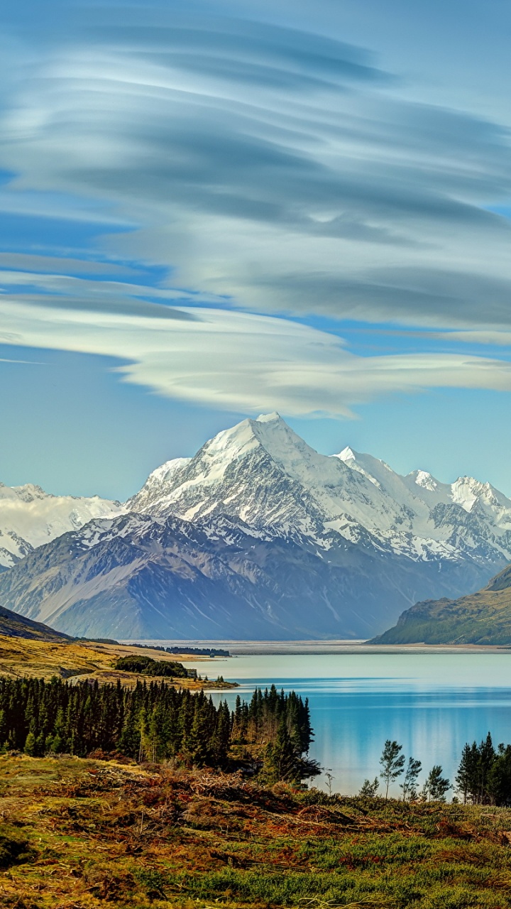 Lake Near Mountain Under Blue Sky During Daytime. Wallpaper in 720x1280 Resolution