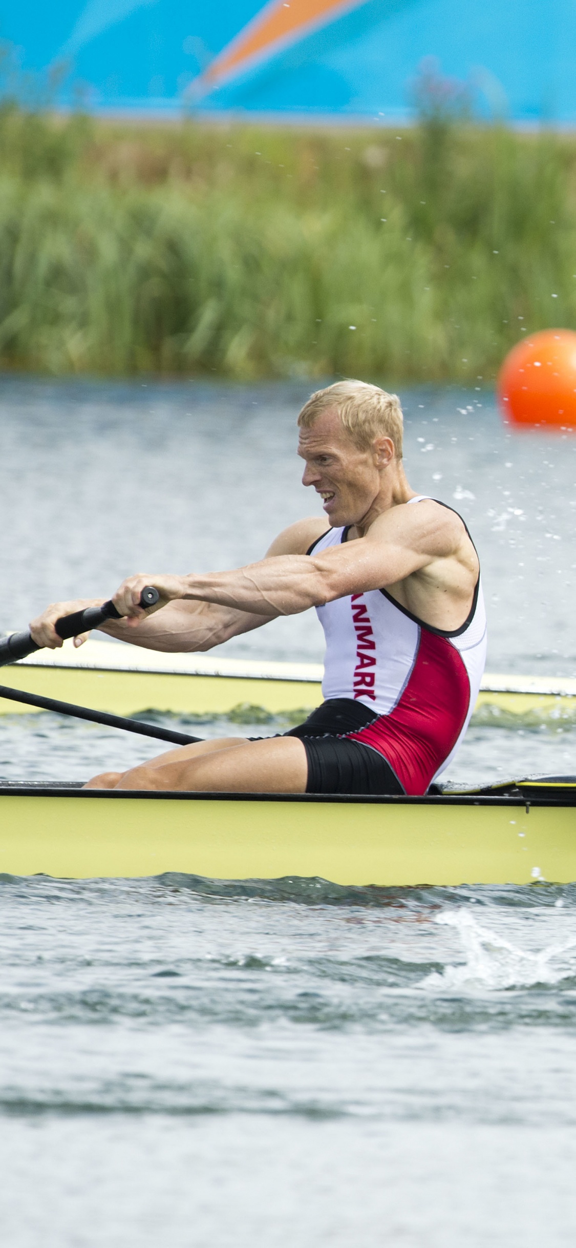 2 Boys in Red and Black Shorts Riding on Blue Kayak on River During Daytime. Wallpaper in 1125x2436 Resolution