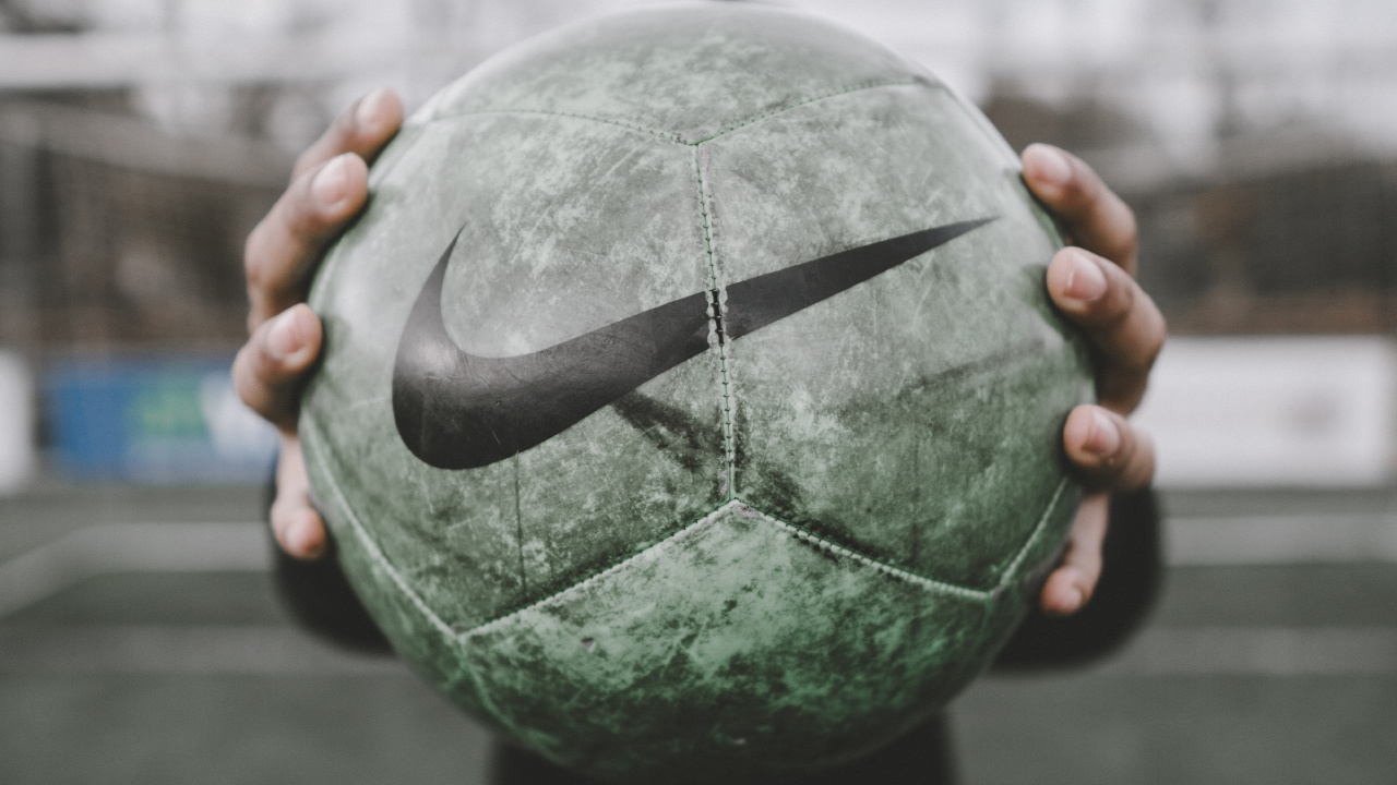 Person Holding Green and Black Ball. Wallpaper in 1280x720 Resolution