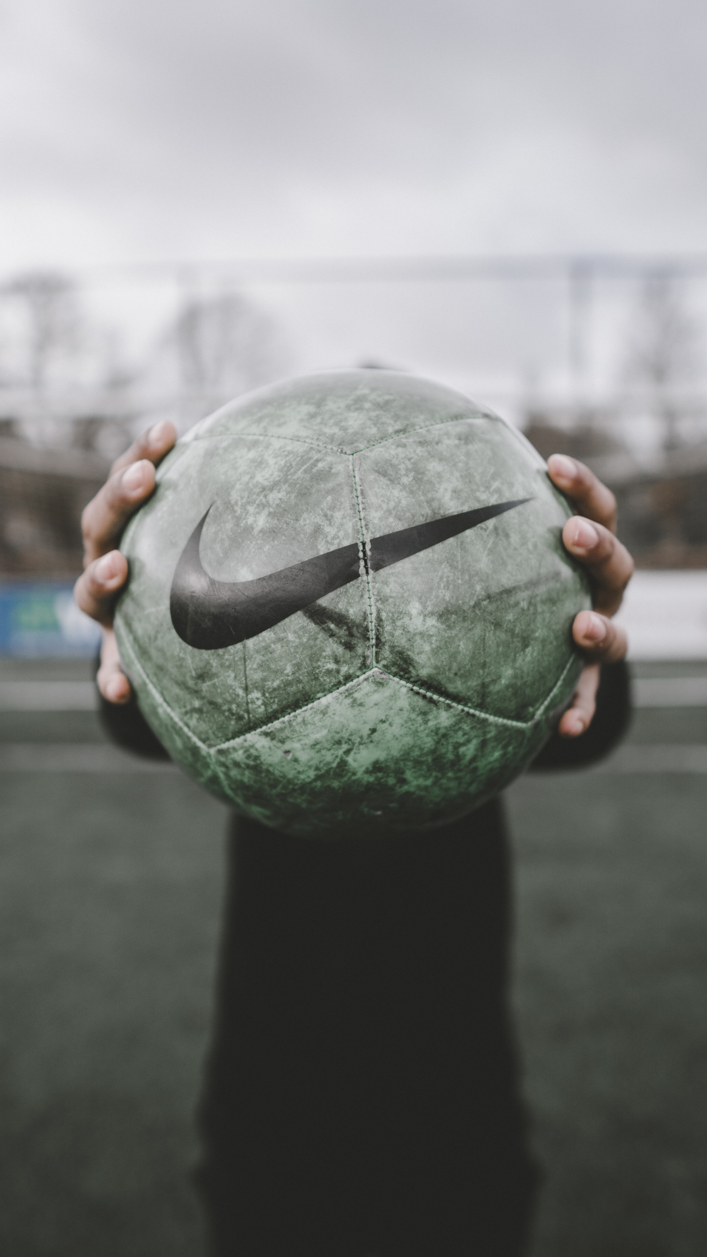 Person Holding Green and Black Ball. Wallpaper in 1440x2560 Resolution