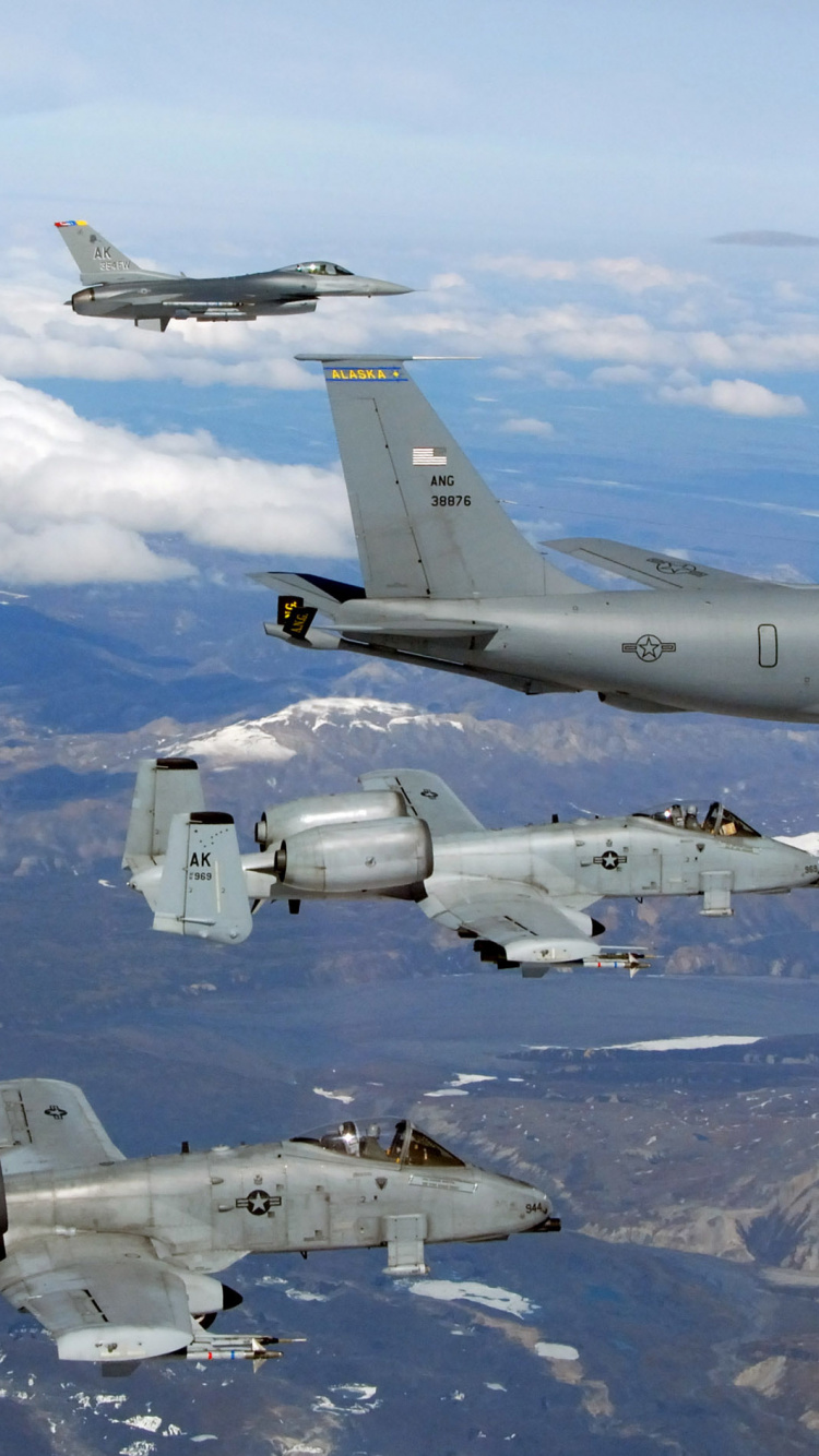 Gray Fighter Plane Flying Over Snow Covered Mountain During Daytime. Wallpaper in 750x1334 Resolution