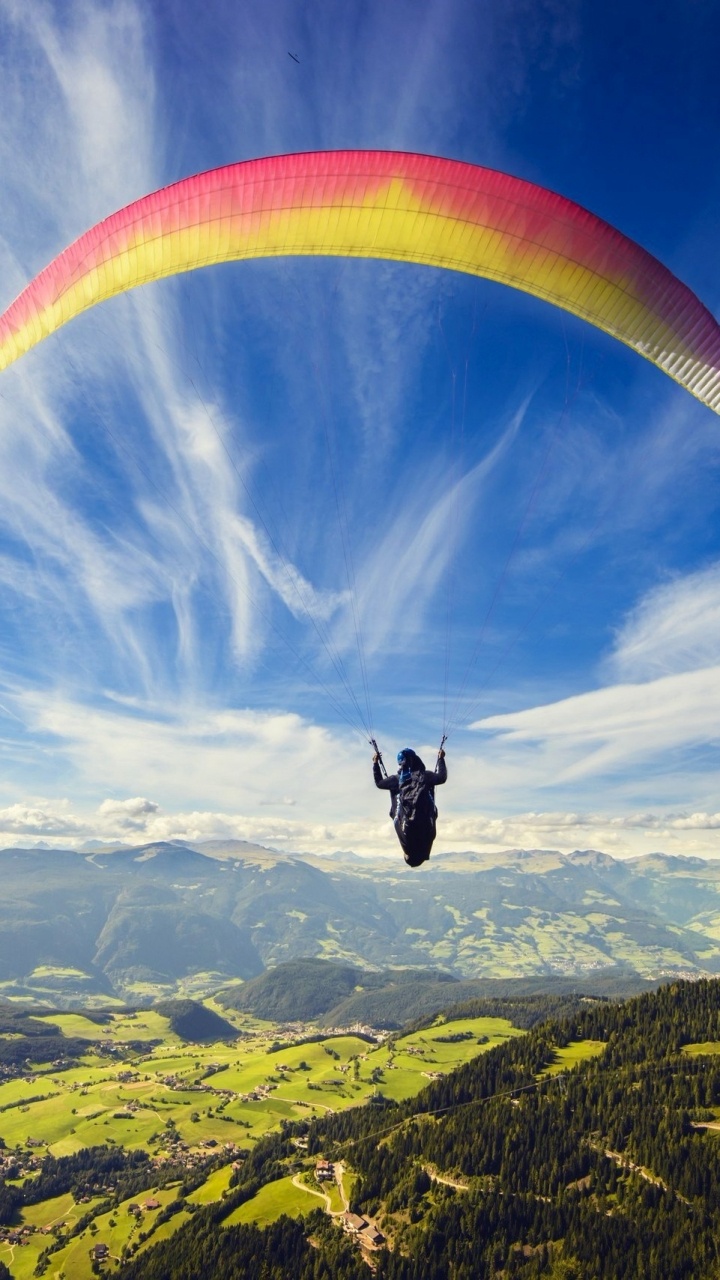 Person in Red and Yellow Parachute Over Green Mountains During Daytime. Wallpaper in 720x1280 Resolution