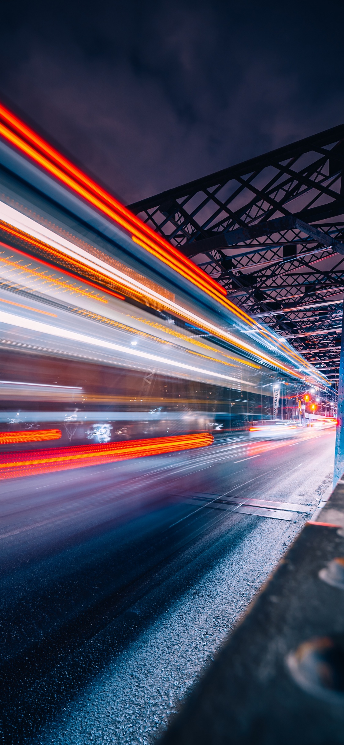 Time Lapse Photography of Cars on Bridge During Night Time. Wallpaper in 1125x2436 Resolution