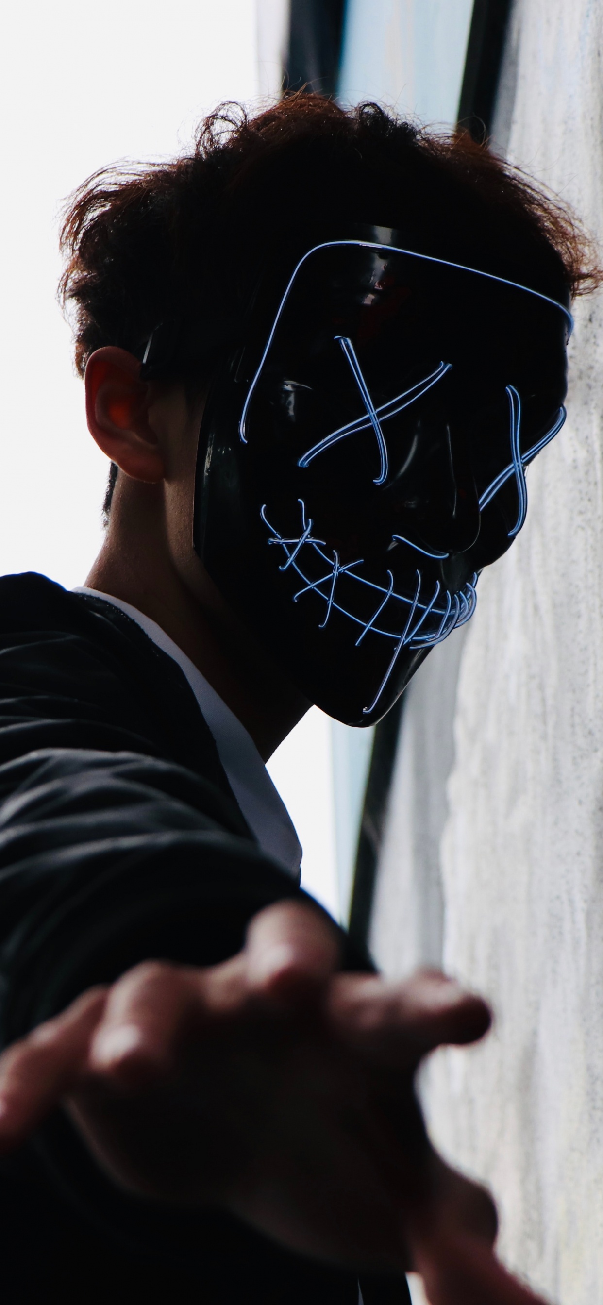 Woman in Black Long Sleeve Shirt Wearing Black and White Mask. Wallpaper in 1242x2688 Resolution