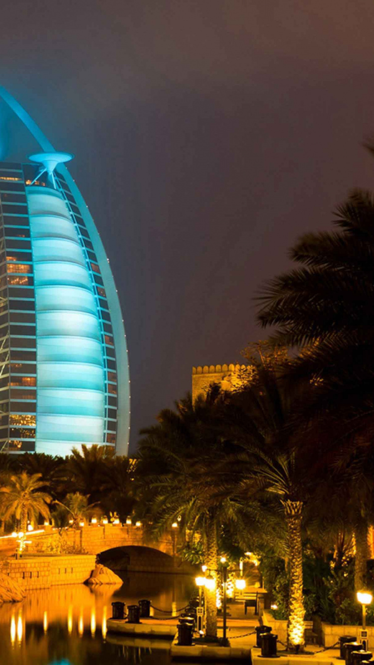 Blue Lighted Building During Night Time. Wallpaper in 750x1334 Resolution