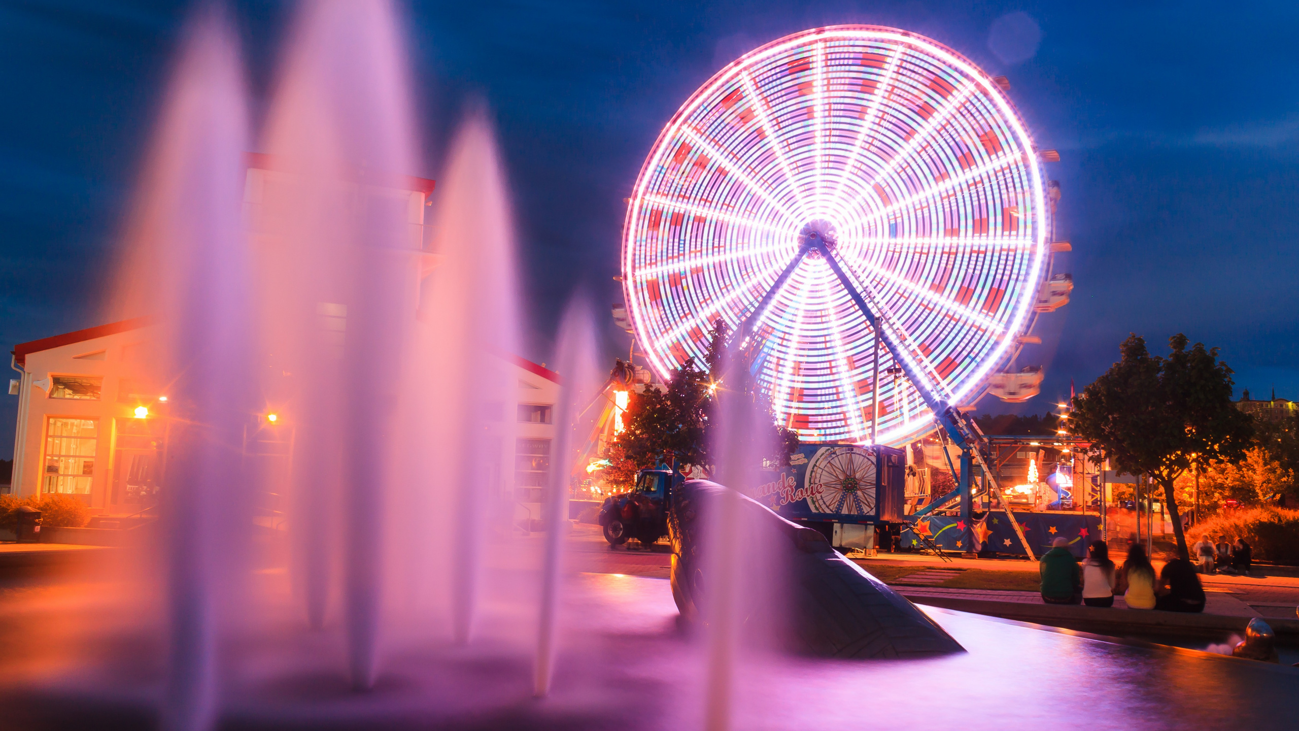 White Round Building With Lights During Night Time. Wallpaper in 2560x1440 Resolution
