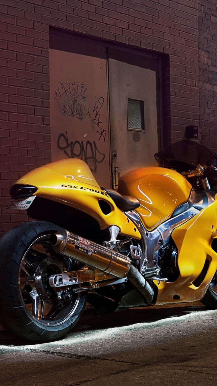 Yellow and Black Sports Bike Parked Beside Brown Brick Wall. Wallpaper in 720x1280 Resolution