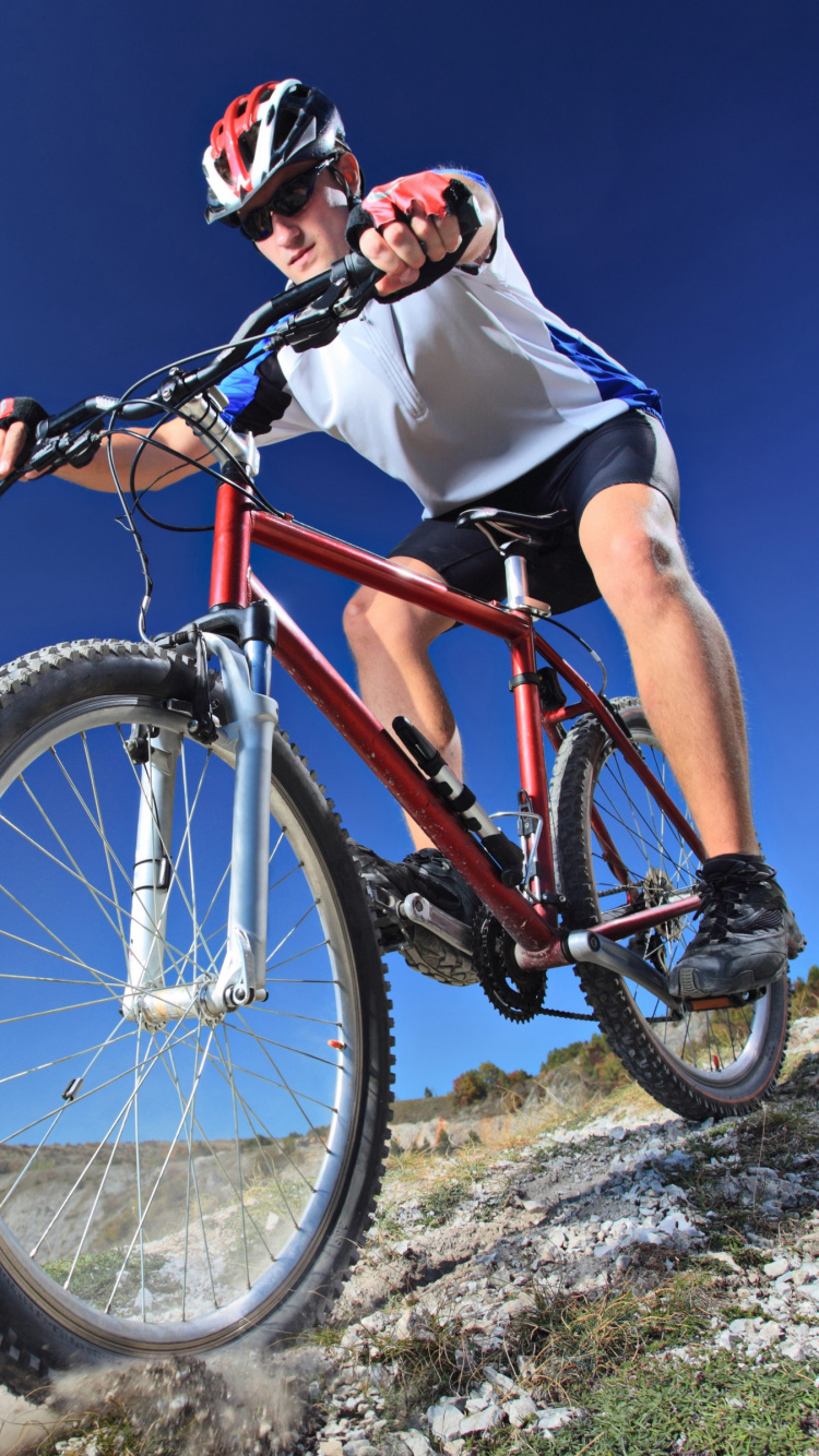 Hombre Con Camisa Blanca Montando en Bicicleta de Montaña Roja Durante el Día. Wallpaper in 750x1334 Resolution