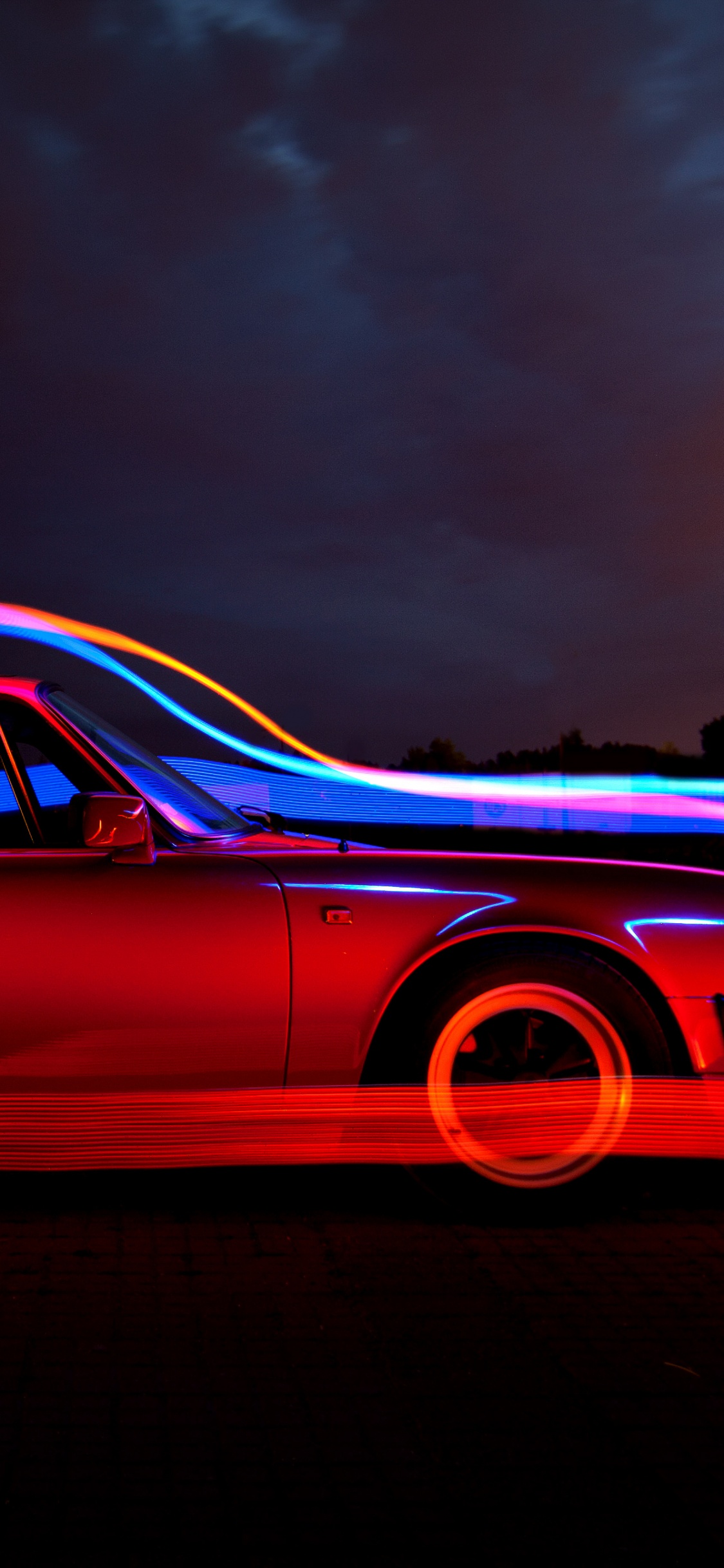 Cupé Rojo Sobre Fondo Negro. Wallpaper in 1125x2436 Resolution