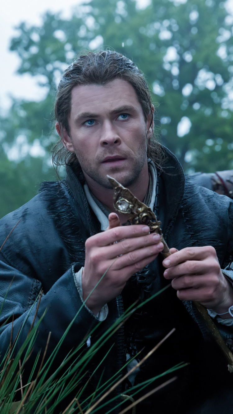 Man in Blue Denim Jacket Holding Brown and Black Snake. Wallpaper in 750x1334 Resolution