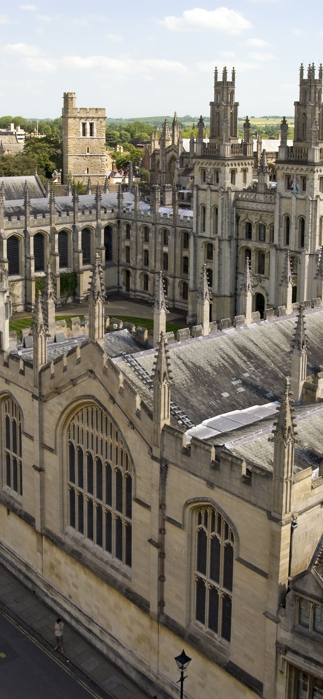 People Walking on Street Near Gray Concrete Building During Daytime. Wallpaper in 1125x2436 Resolution