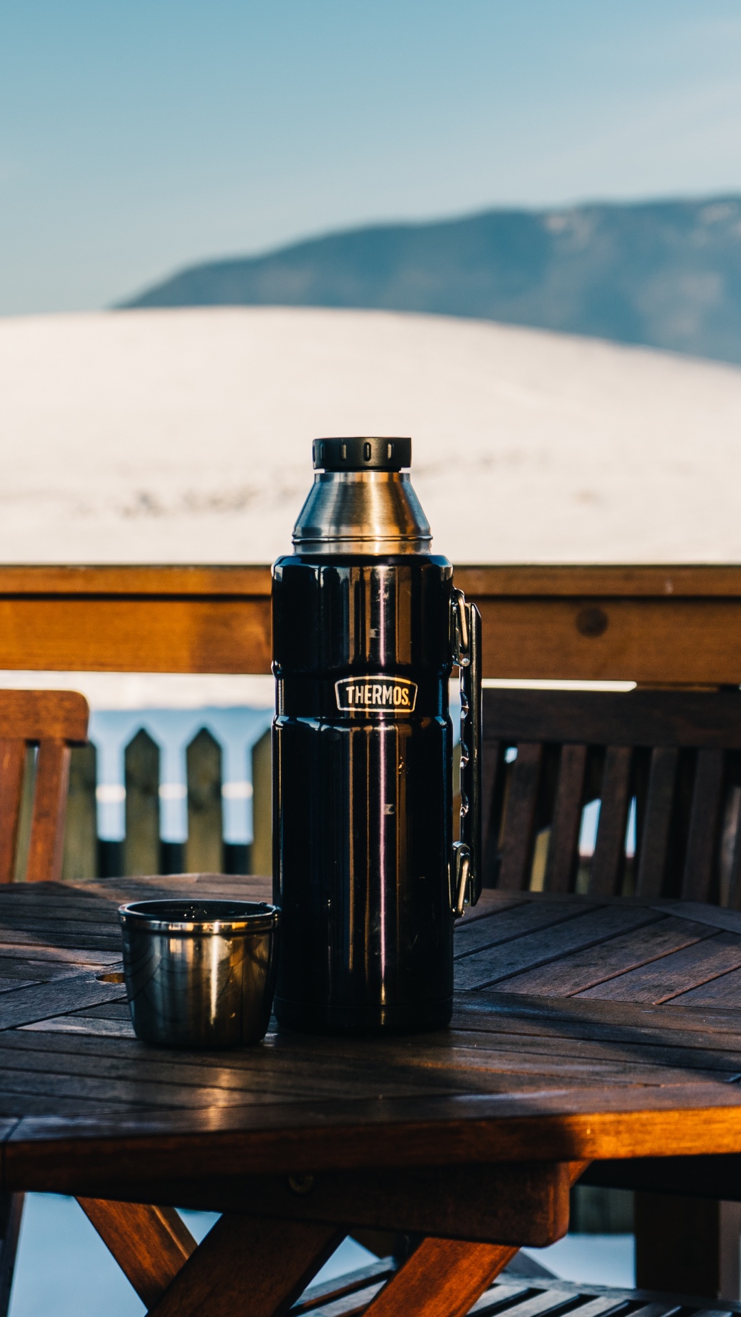 Black Vacuum Flask on Brown Wooden Table. Wallpaper in 1080x1920 Resolution