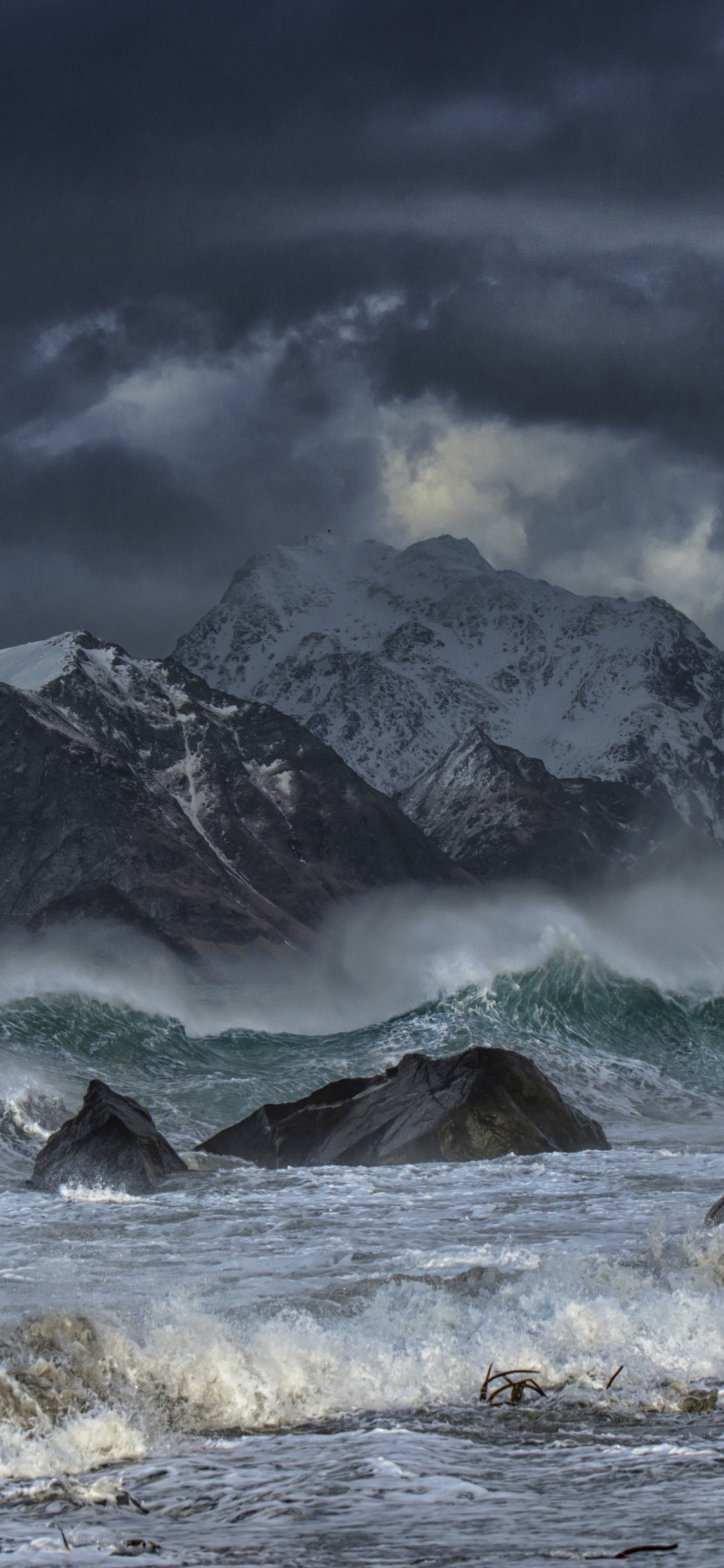 Snow Covered Mountain Under Cloudy Sky During Daytime. Wallpaper in 1125x2436 Resolution