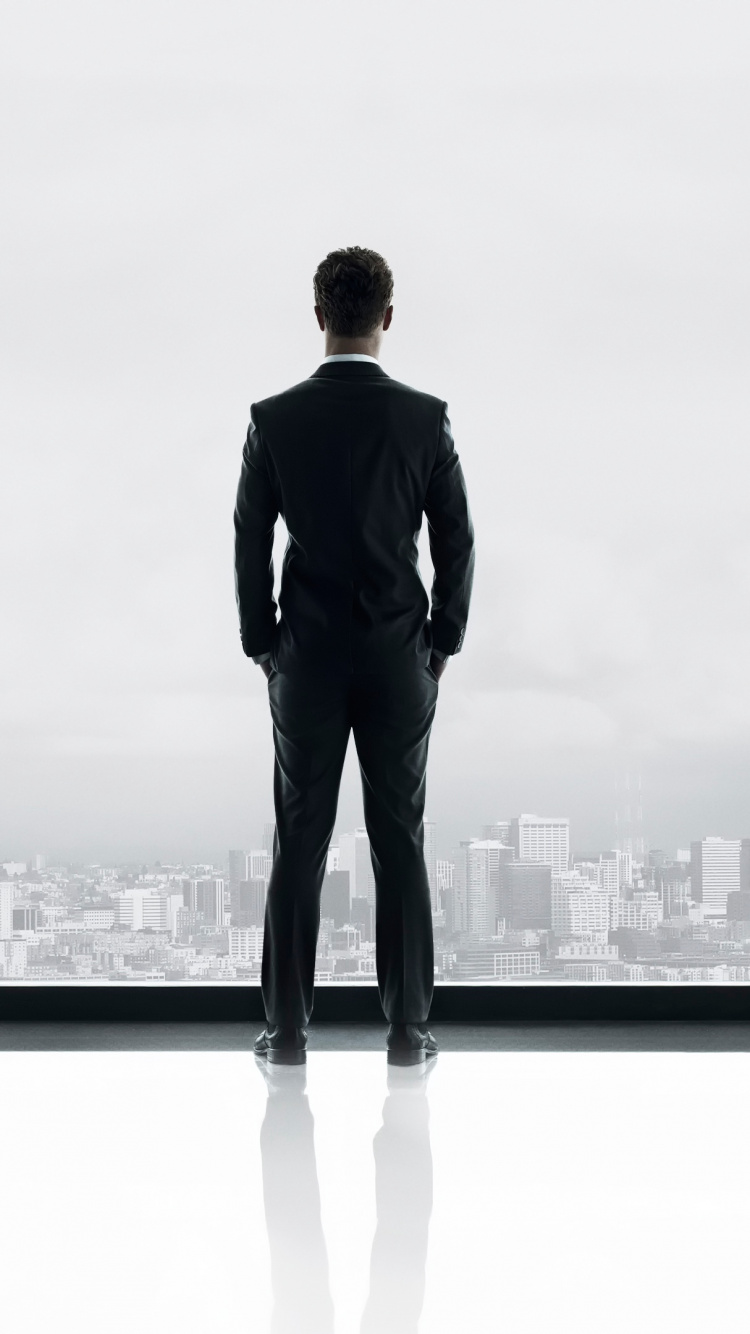 Man in Black Suit Standing on White Wooden Railings. Wallpaper in 750x1334 Resolution