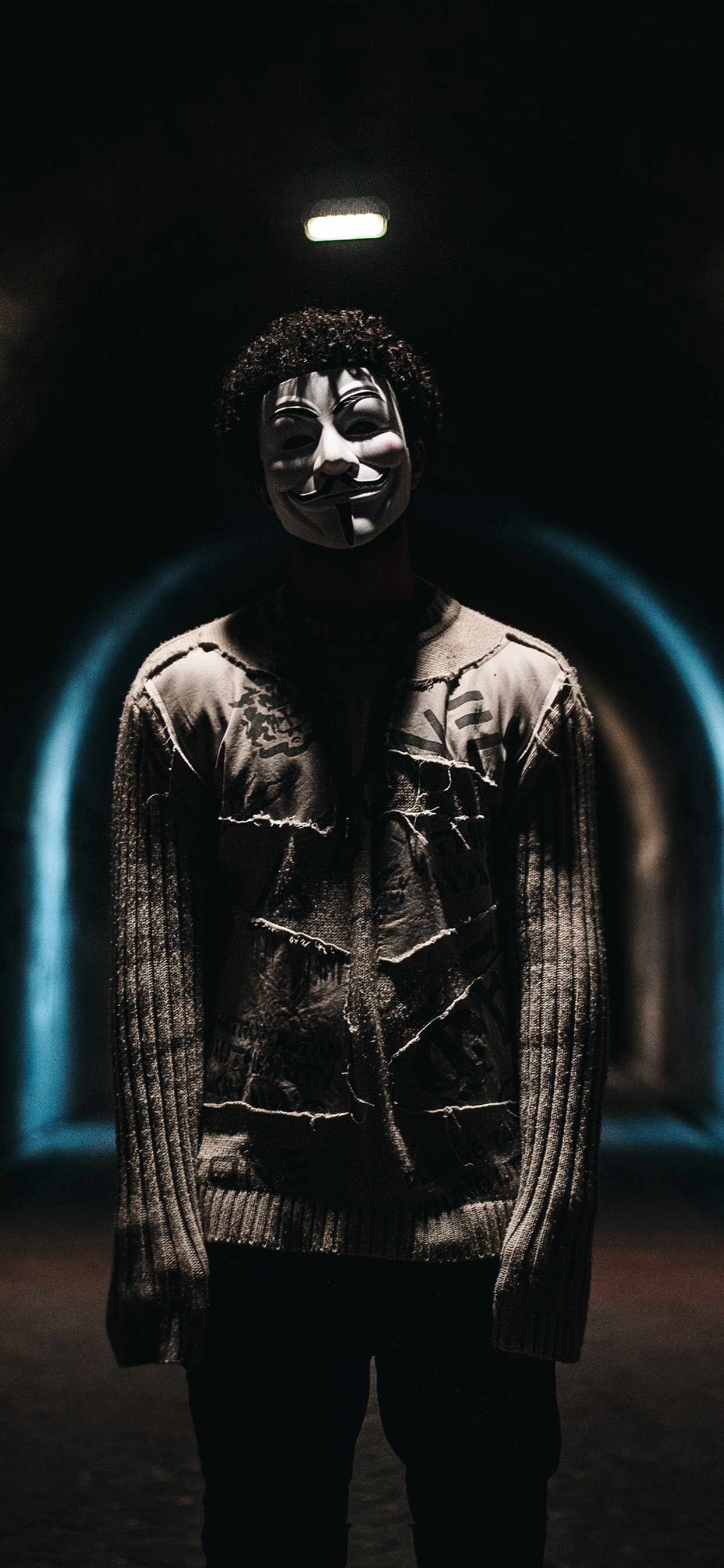 Man in Black Leather Jacket Standing in Tunnel. Wallpaper in 1242x2688 Resolution