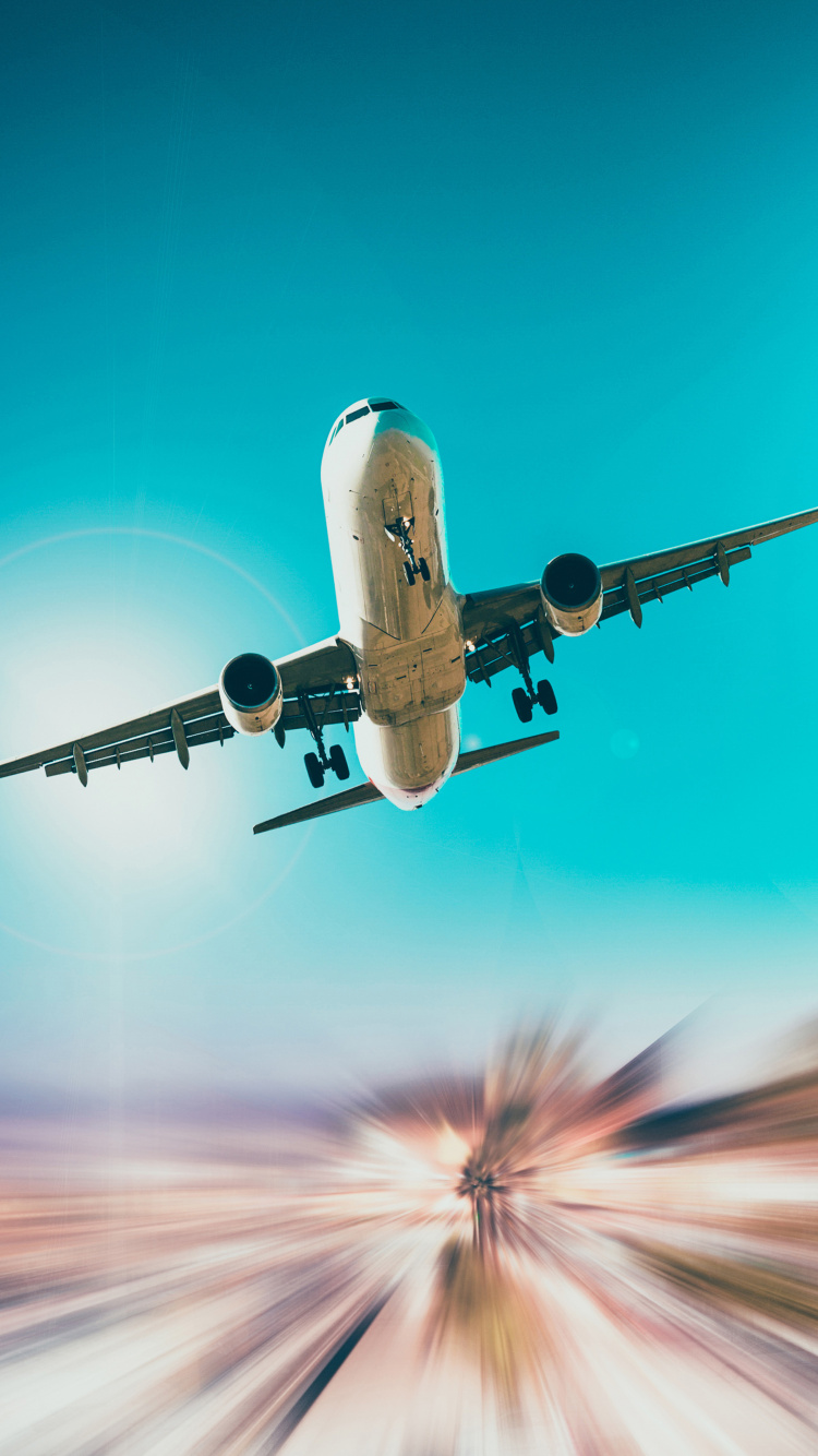 Weißes Und Blaues Flugzeug im Flug. Wallpaper in 750x1334 Resolution