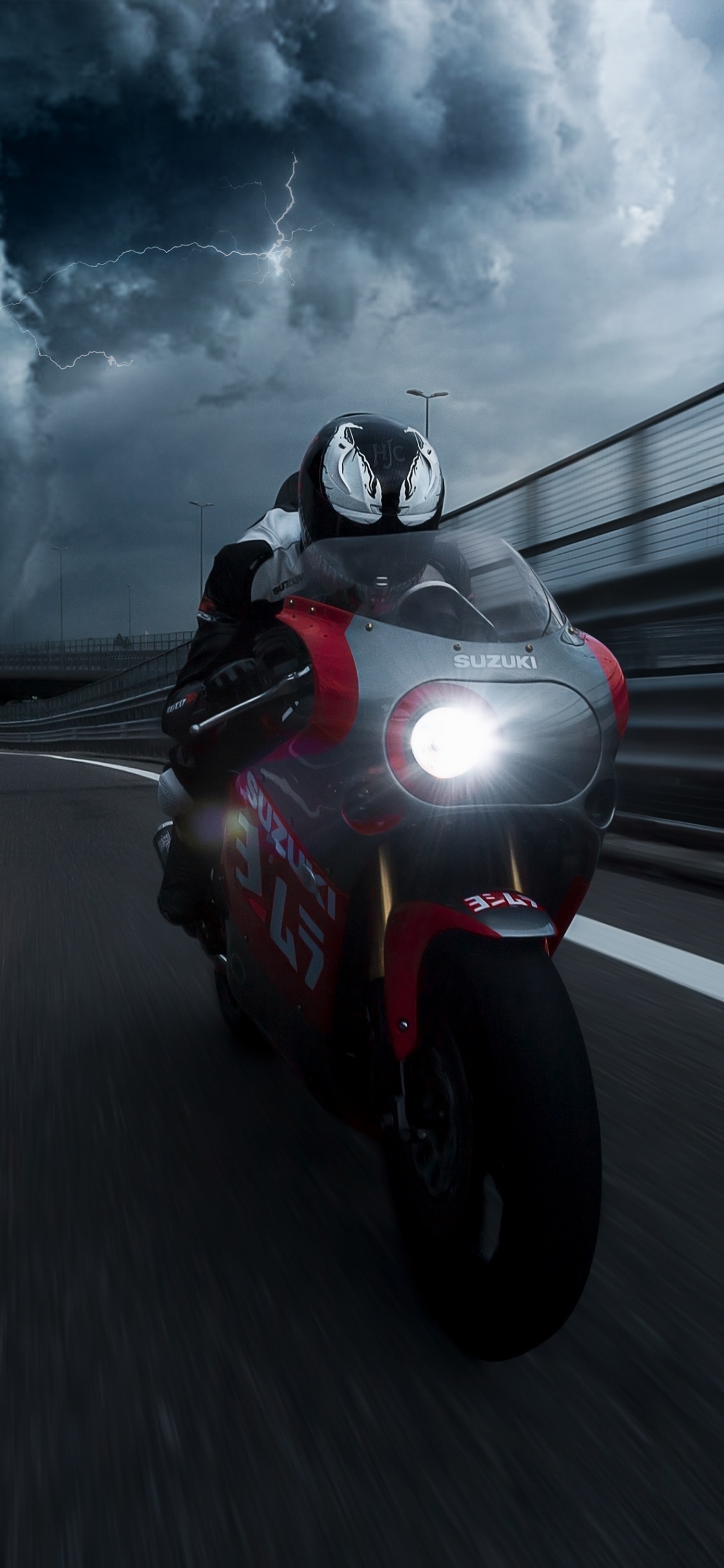 Red and Black Sports Bike on Road During Night Time. Wallpaper in 1125x2436 Resolution