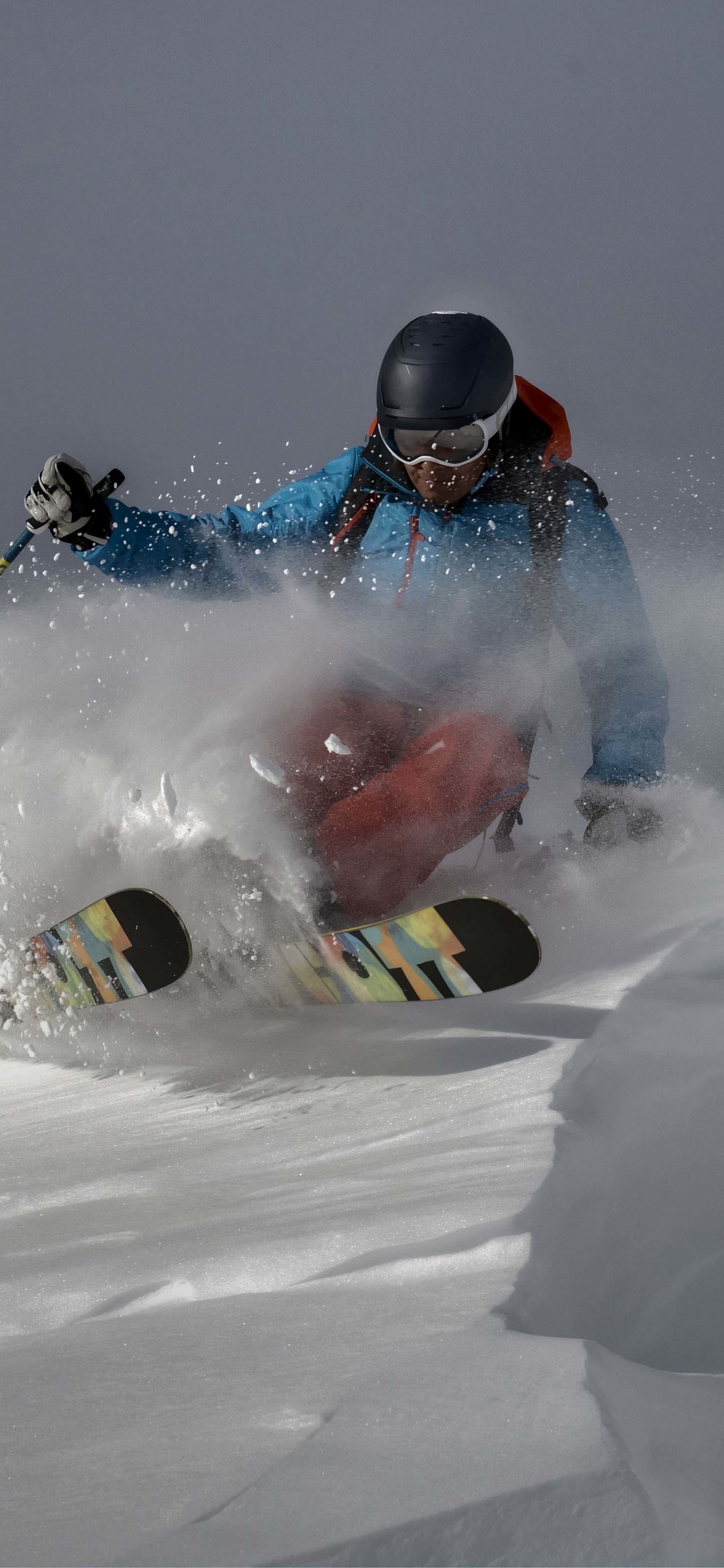Man Riding on Red and White Snow Mobile During Daytime. Wallpaper in 1125x2436 Resolution