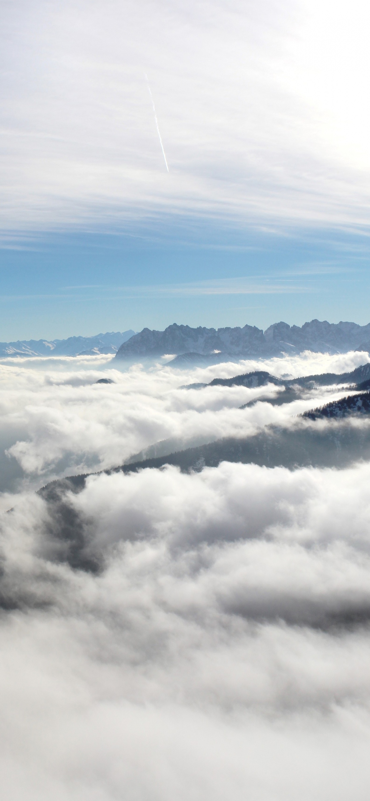White Clouds Over Snow Covered Mountains. Wallpaper in 1242x2688 Resolution