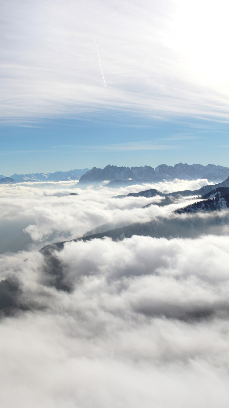 White Clouds Over Snow Covered Mountains. Wallpaper in 750x1334 Resolution