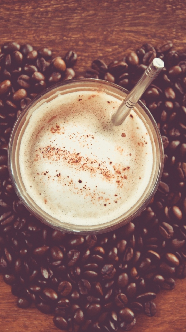 White Liquid in Clear Drinking Glass on Brown Coffee Beans. Wallpaper in 720x1280 Resolution