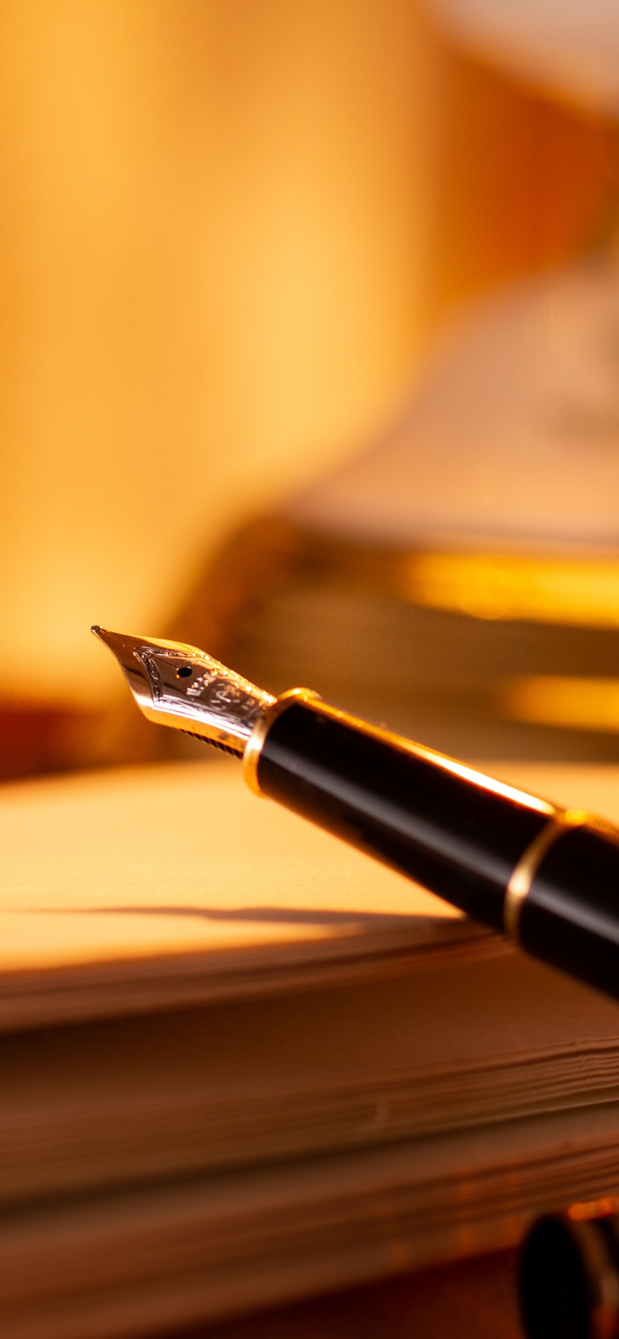 Black and Gold Fountain Pen on Brown Wooden Table. Wallpaper in 1242x2688 Resolution