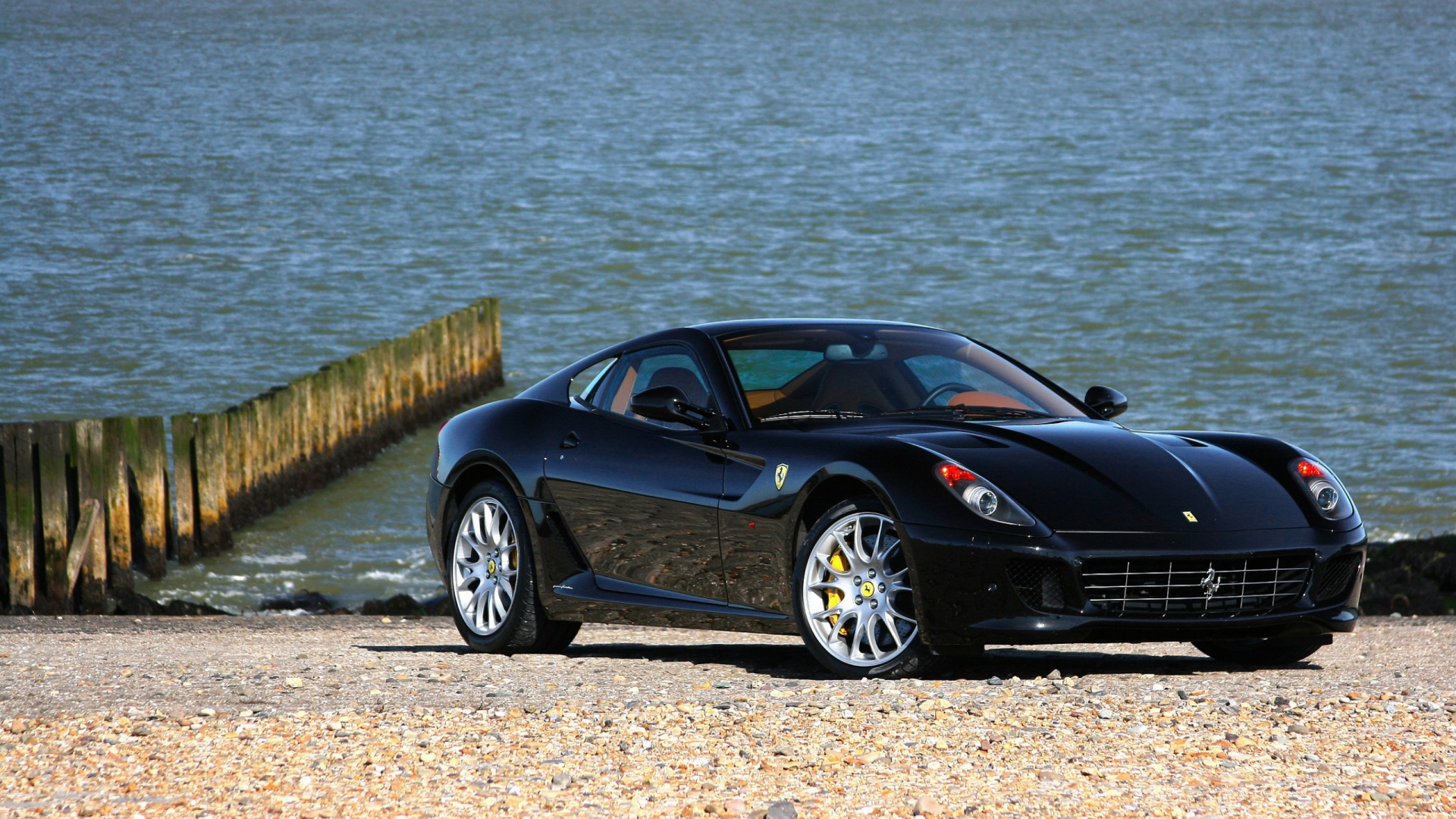 Black Porsche 911 Parked Near Body of Water During Daytime. Wallpaper in 1920x1080 Resolution